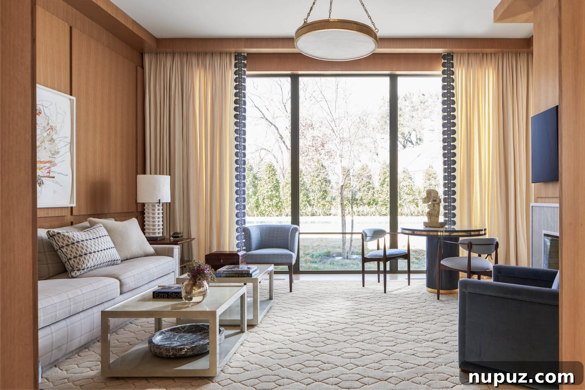 An elegant and welcoming living room designed by Jenkins Interiors, showcasing plush, comfortable furniture, refined finishes, and abundant natural light that fills the space with a serene ambiance. Photographed by Nathan Schroder.
