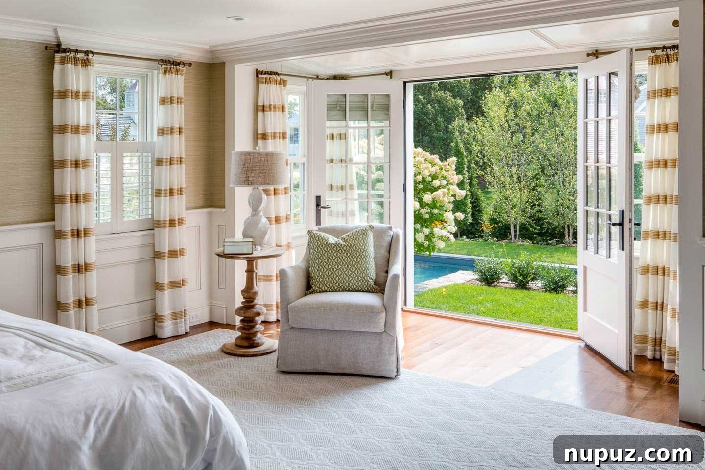 Primary bedroom in Chatham beach house with neutral colors and pool view
