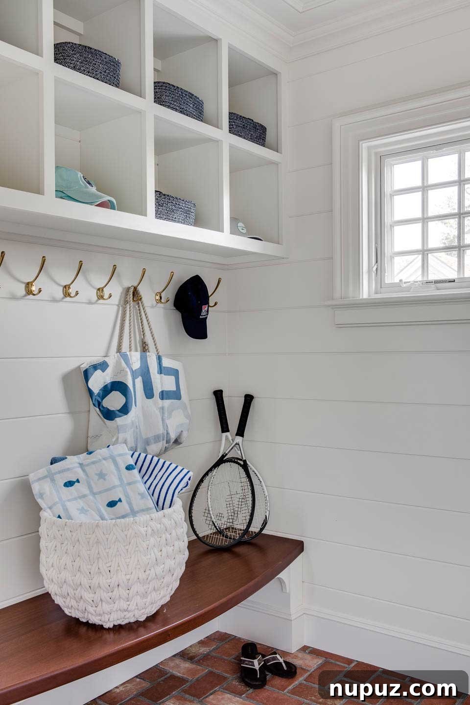 Chatham beach house mudroom with herringbone brick floor and white shiplap