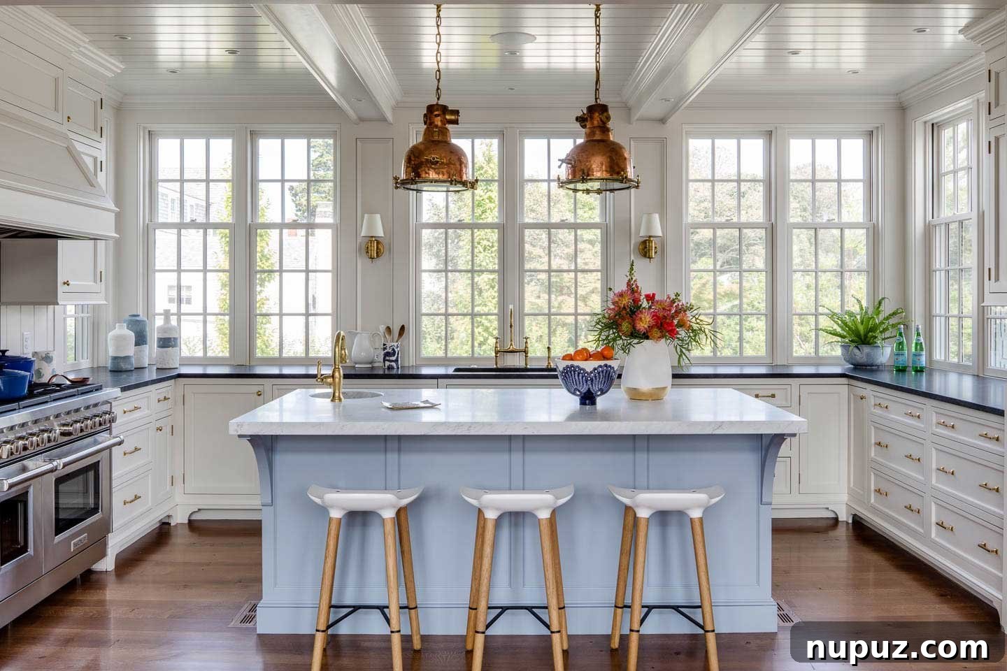 Chatham beach house kitchen with blue island and copper pendants