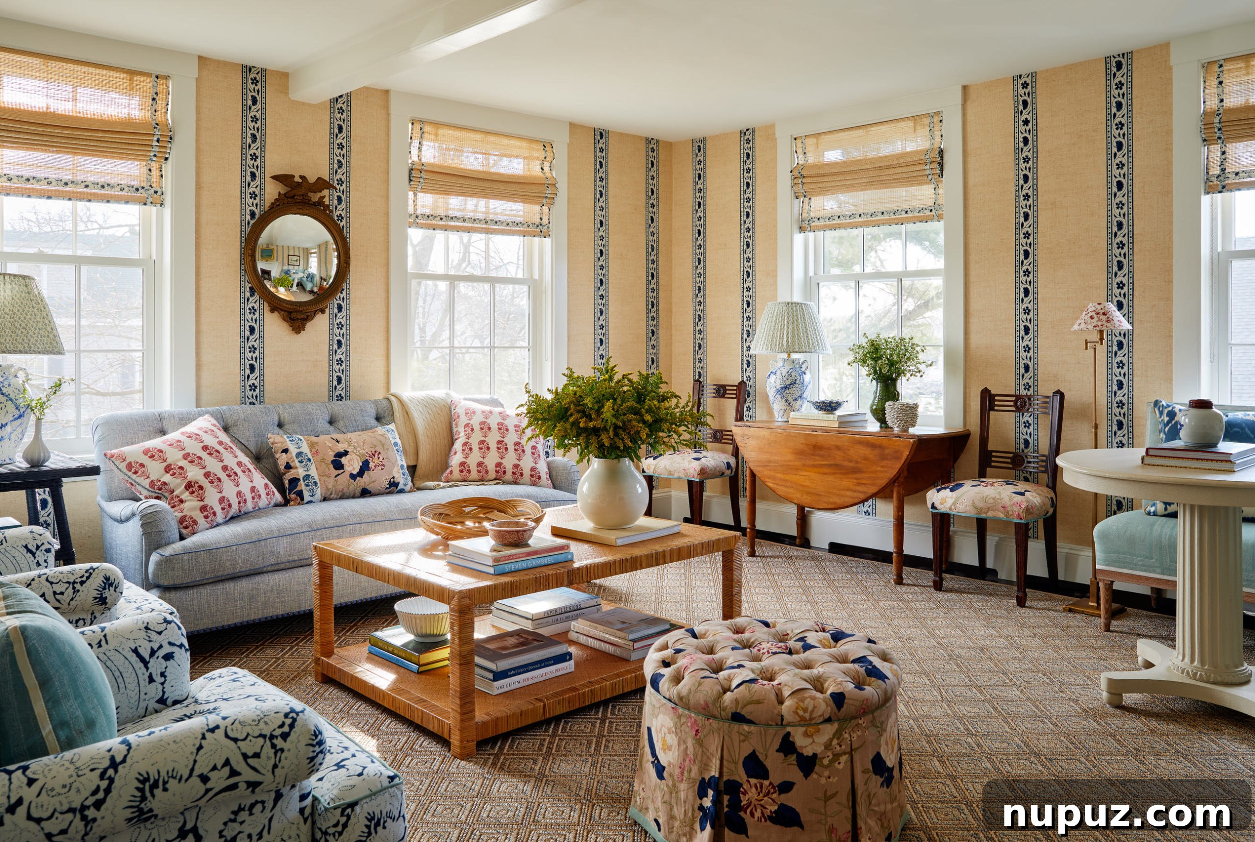Living room with decor and elegant wallpaper that adds character to the home. Thoughtful styling for a unique aesthetic.