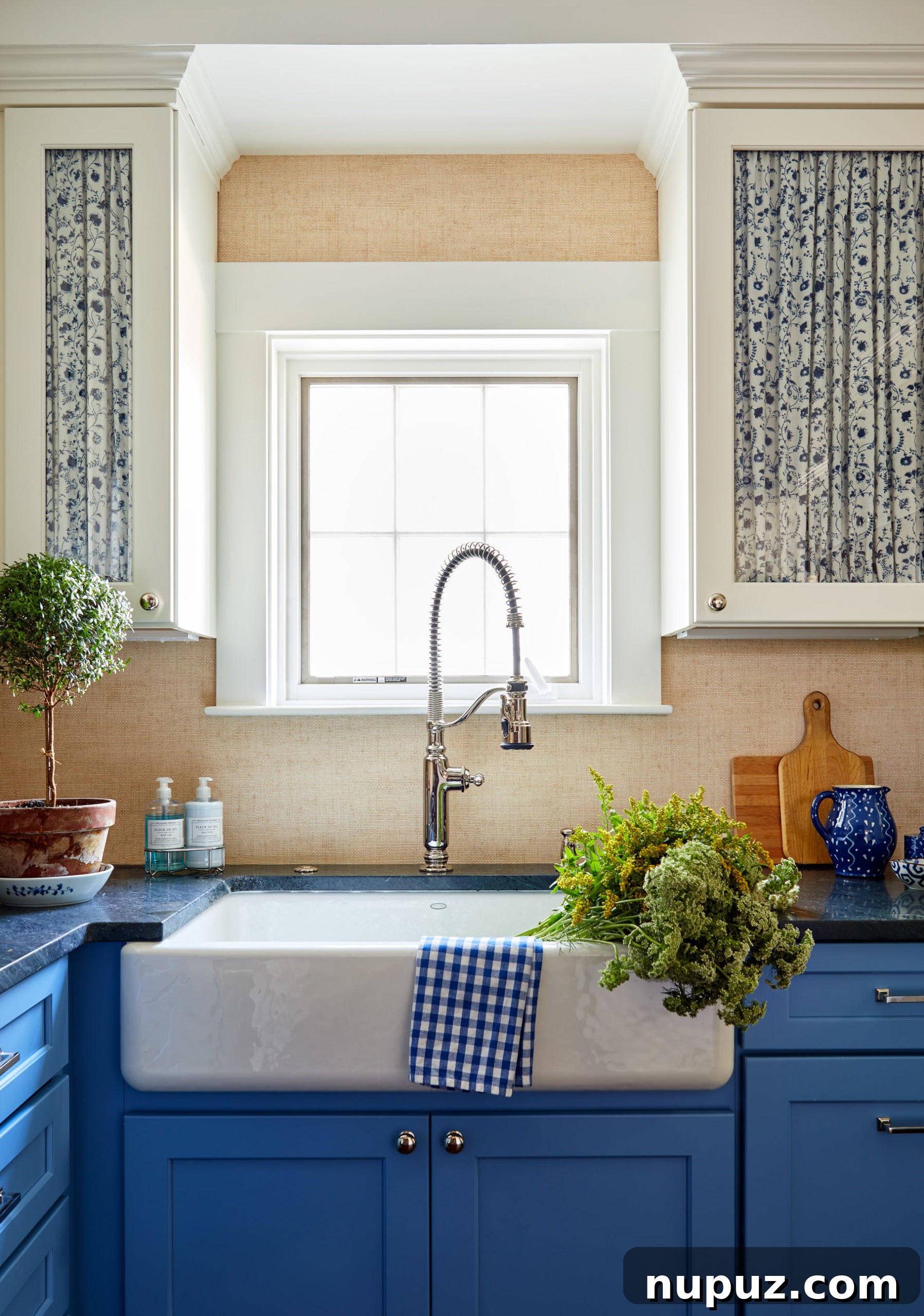 Kitchen with blue and white curtains and grasscloth wallpaper. This design choice adds character and warmth. Photos by Read McKendree, Styled by Alexandra Morris, Construction & Contracting by RB Wood Contracting.