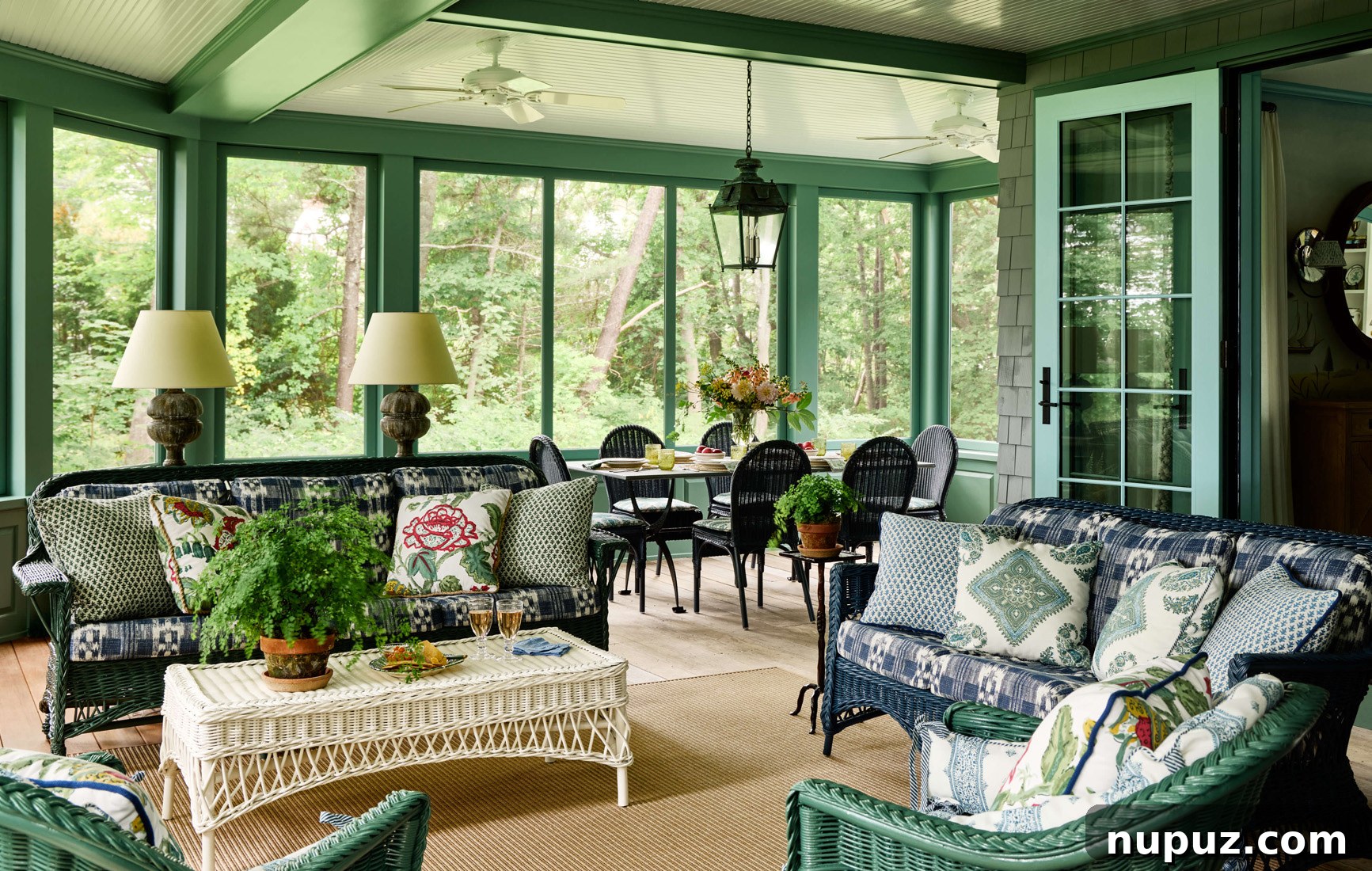 Charming sunny porch, beautifully decorated as an outdoor living room, inviting relaxation and enjoyment of the natural surroundings.