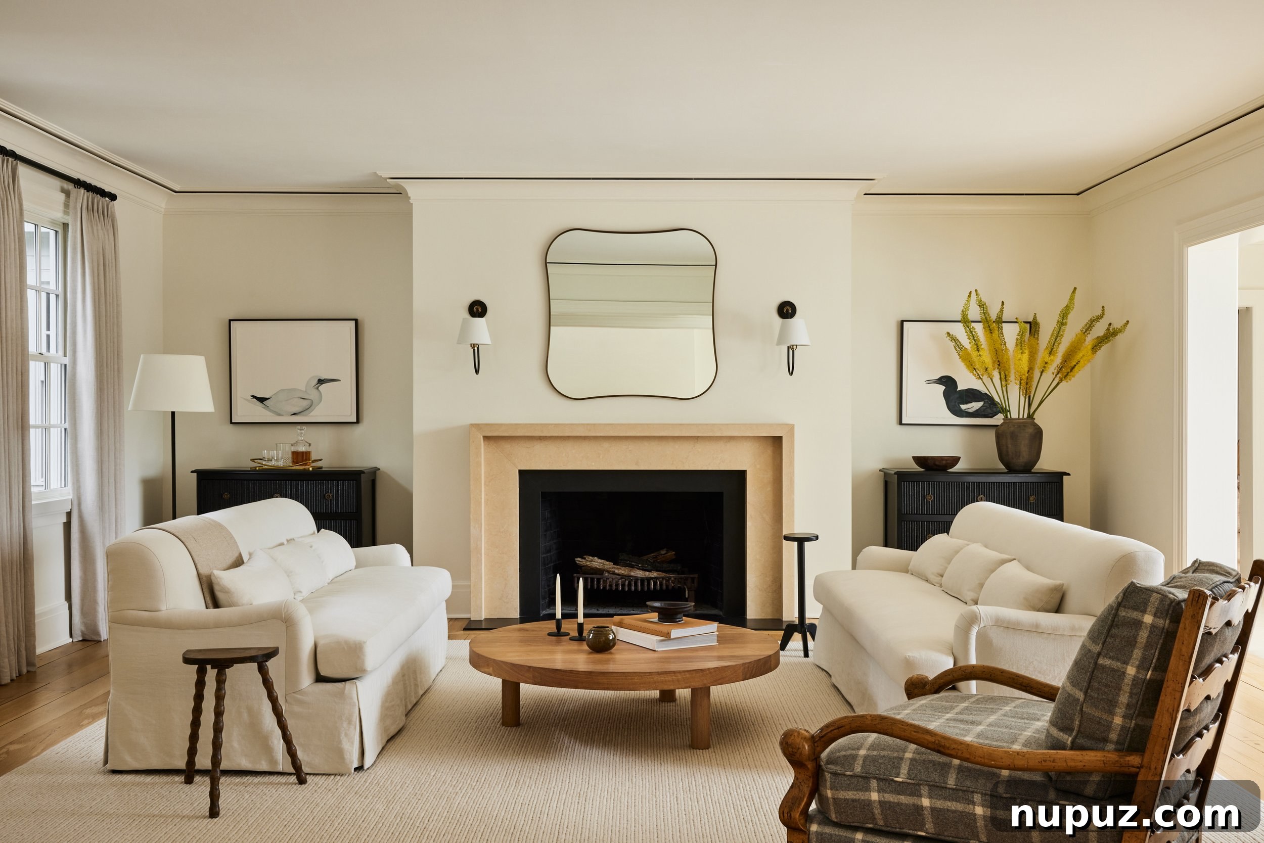 An Ursino Interiors living space showcasing a plush L-shaped sofa, a minimalist coffee table, and an intriguing art piece. The design combines rich textures with clean lines for a sophisticated yet comfortable feel.
