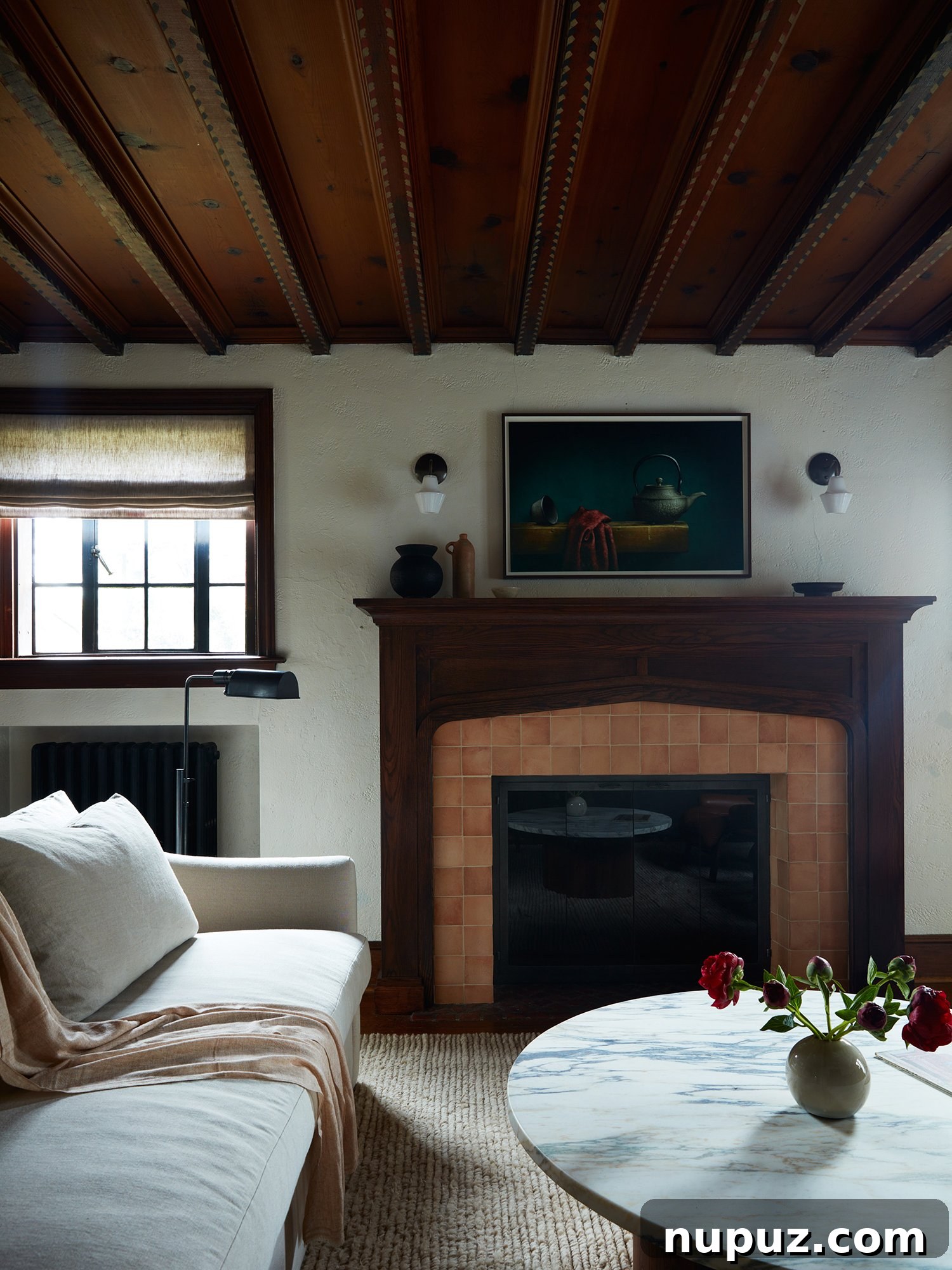 A light-filled Ursino Interiors living room with expansive windows, a cream-colored sofa, and natural wood accents. The design emphasizes openness and connection to the outdoors, creating a serene and sophisticated haven.