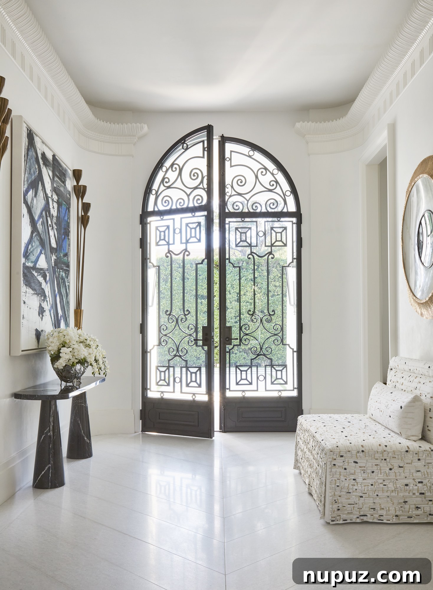 Inside a Palm Beach Home Redefining Modern Elegance 2 Stunning Palm Beach Regency estate entrance with lush landscaping, a perfect blend of timeless glamour and modern ease by Enda Donagher Architect and Elizabeth Martell. Photography by Mark Roskams.