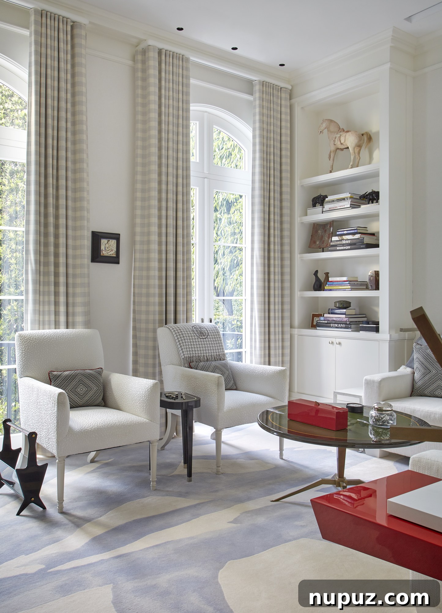 Inside a Palm Beach Home Redefining Modern Elegance 7 Sophisticated corner of the living room highlighting a curated art collection and elegant furnishings, designed for both aesthetic pleasure and comfortable living.