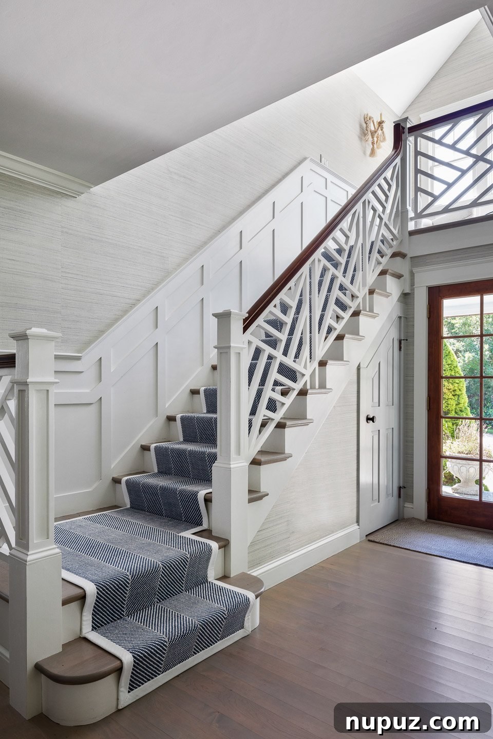 Matunuck Beach coastal home exterior with warm lighting and inviting entrance designed by Digs Design Company