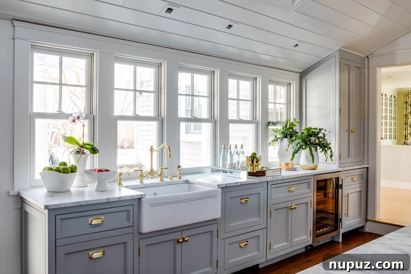 Coastal kitchen with white cabinetry, modern appliances, and a central island for entertaining