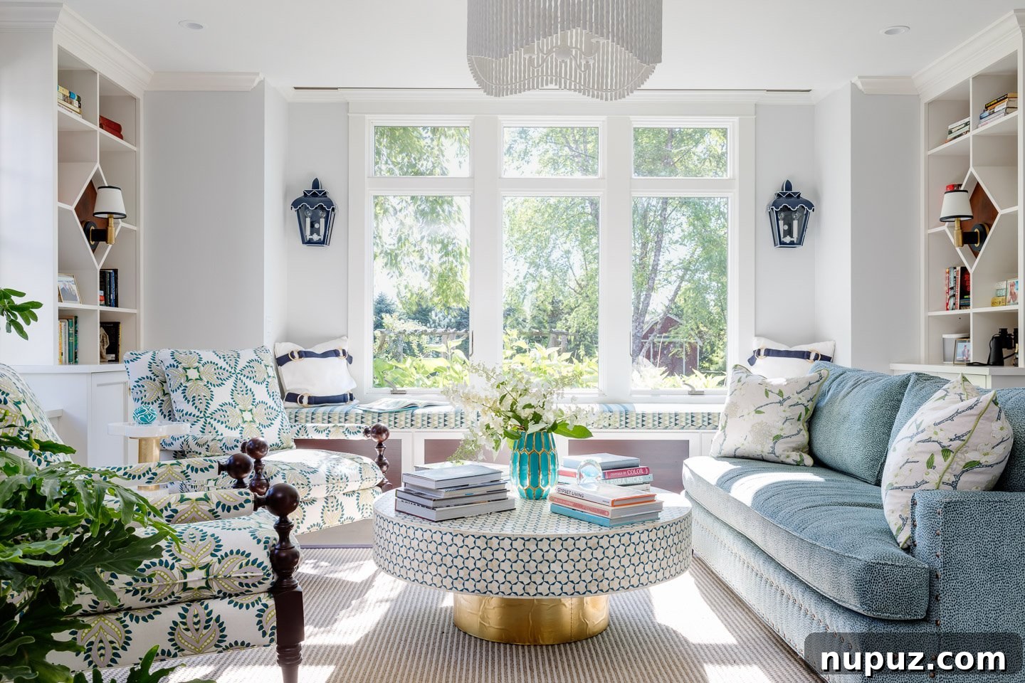 Bright coastal dining area with a long wooden table, comfortable seating, and serene beach vibes