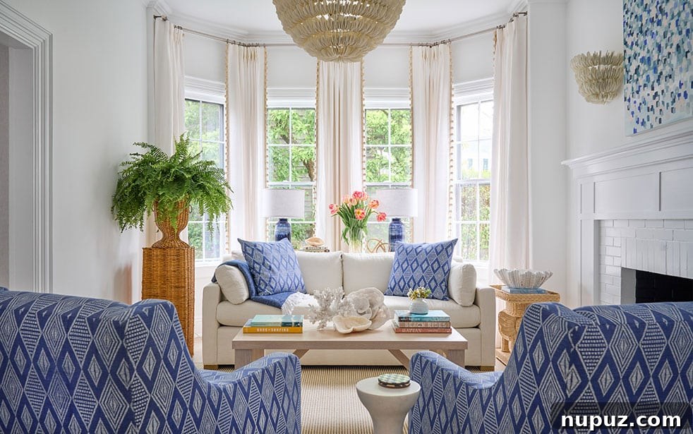 Dynamic living room by Nina Liddle Design featuring crisp blue and white decor paired with bold modern art, photographed by Jane Beiles.