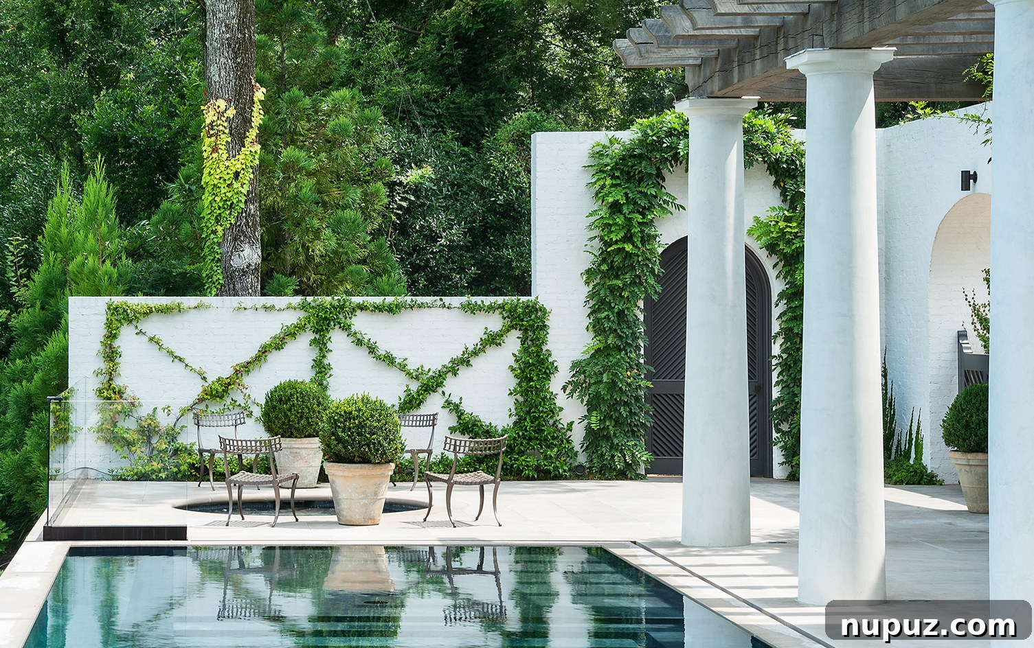 Beautiful outdoor area with a refreshing pool and picturesque climbing vines, designed by Paul Bates Architect and Patti Woods Interiors.