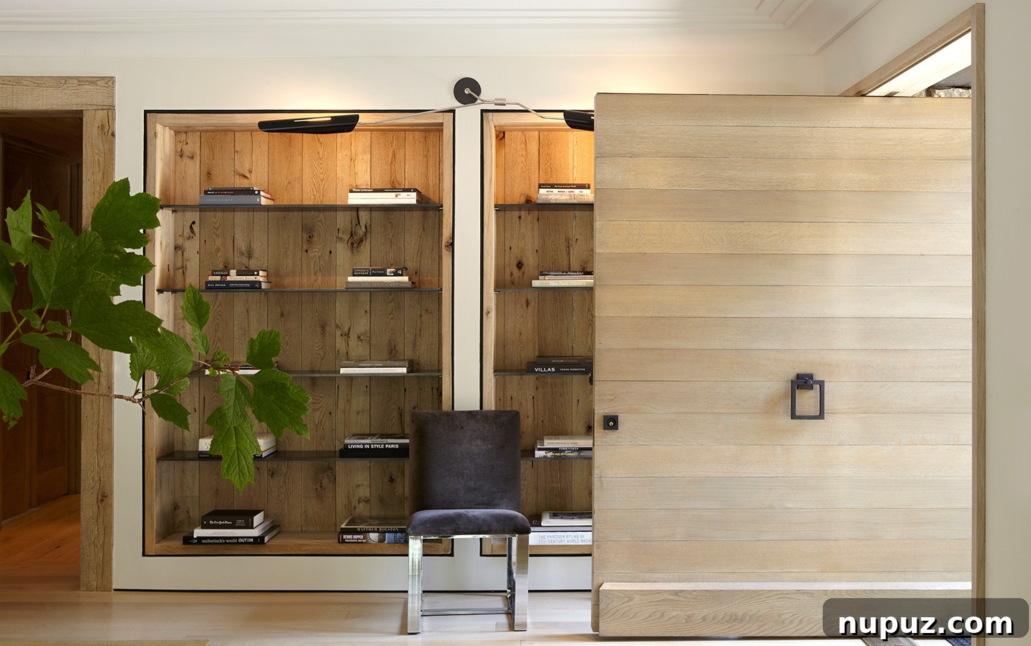 Inviting home entry hall featuring neutral decor and exquisite blonde wood paneling, a collaborative design by Paul Bates Architecture and Betsy Brown Interiors.