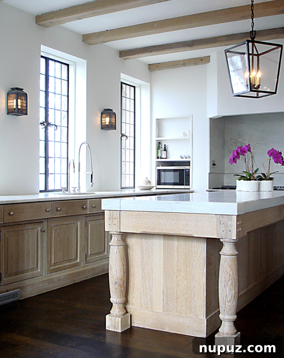 Contemporary kitchen by Paul Bates Architecture and Interiors, featuring light blonde wood and exquisite honed marble countertops, perfect for modern living.