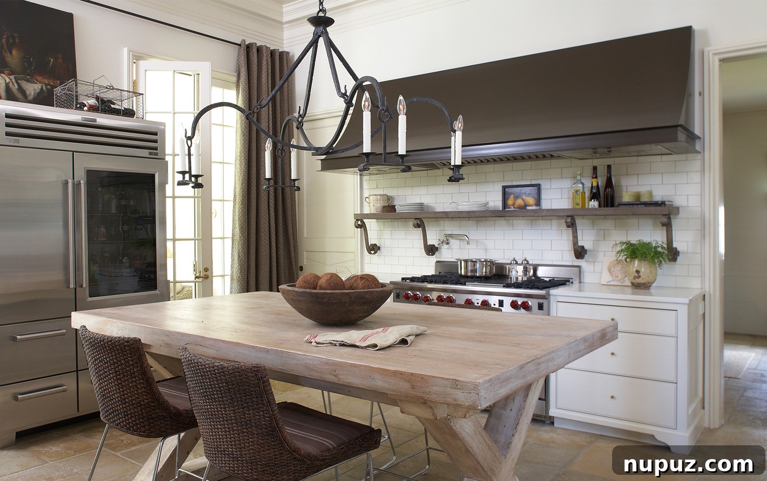 Sophisticated kitchen by Paul Bates Architecture and Interiors, showcasing blonde wood finishes and luxurious honed marble countertops.