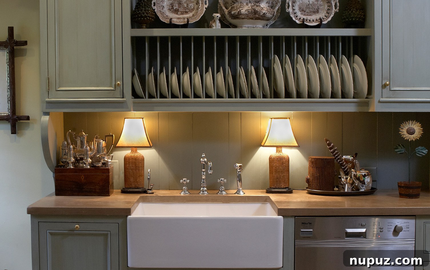 Charming kitchen with distinctive green cabinets, butcher block countertops, and an elegant plate rack, a design collaboration by Paul Bates Architect and Mary McCollister Finch Design.