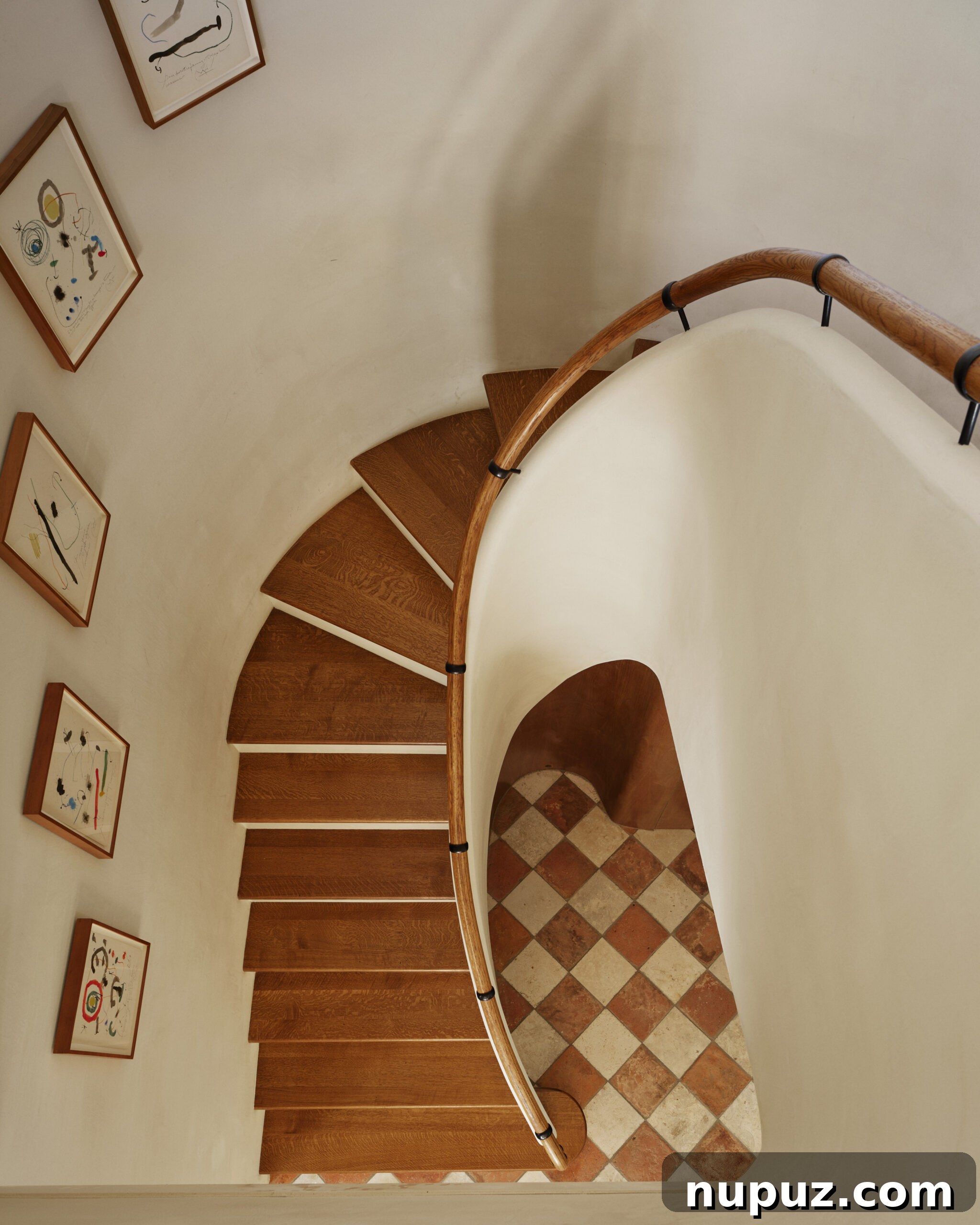 Elegance Redefined: Fusing Modern and Traditional Interior Styles 3 An exquisite curved staircase with a striking checkerboard floor, demonstrating Curtis and Windham's blend of grand architectural features and classic interior design details.