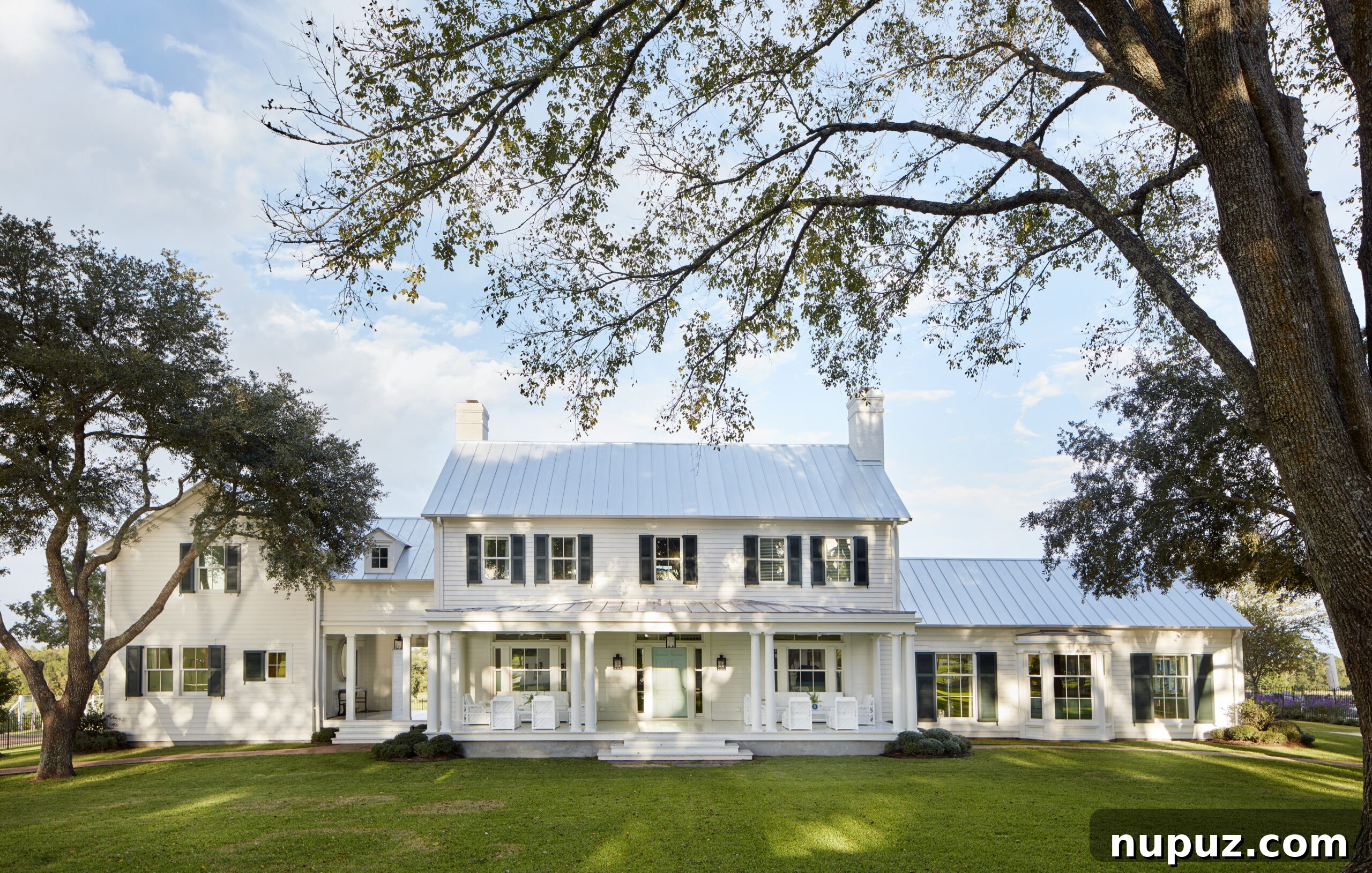 Elegance Redefined: Fusing Modern and Traditional Interior Styles 6 A beautiful traditional white clapboard home by Curtis and Windham, exemplifying timeless American architectural aesthetics and elegant curb appeal.