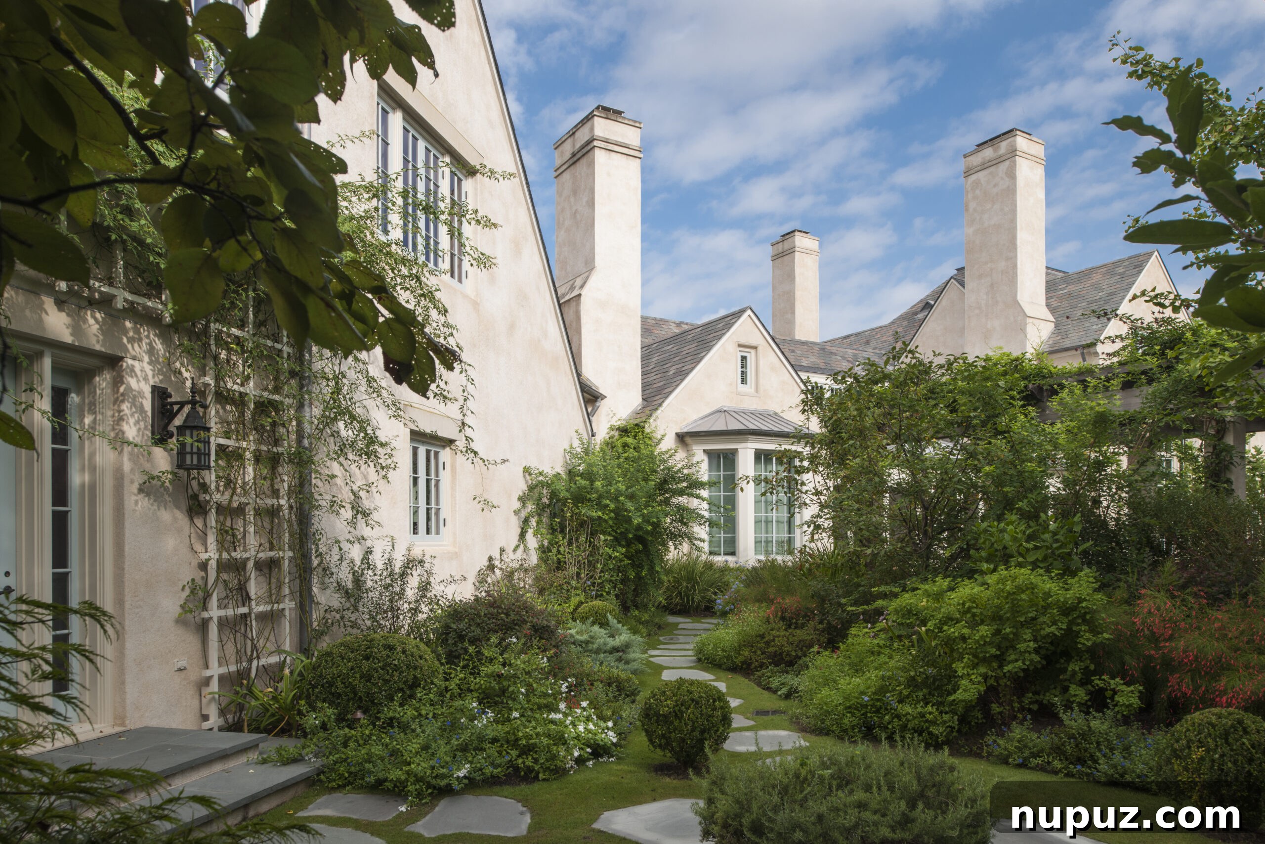 Elegance Redefined: Fusing Modern and Traditional Interior Styles 7 A meticulously designed garden, reflecting the serene beauty and structured elegance characteristic of Curtis and Windham's landscape architecture and traditional home settings.