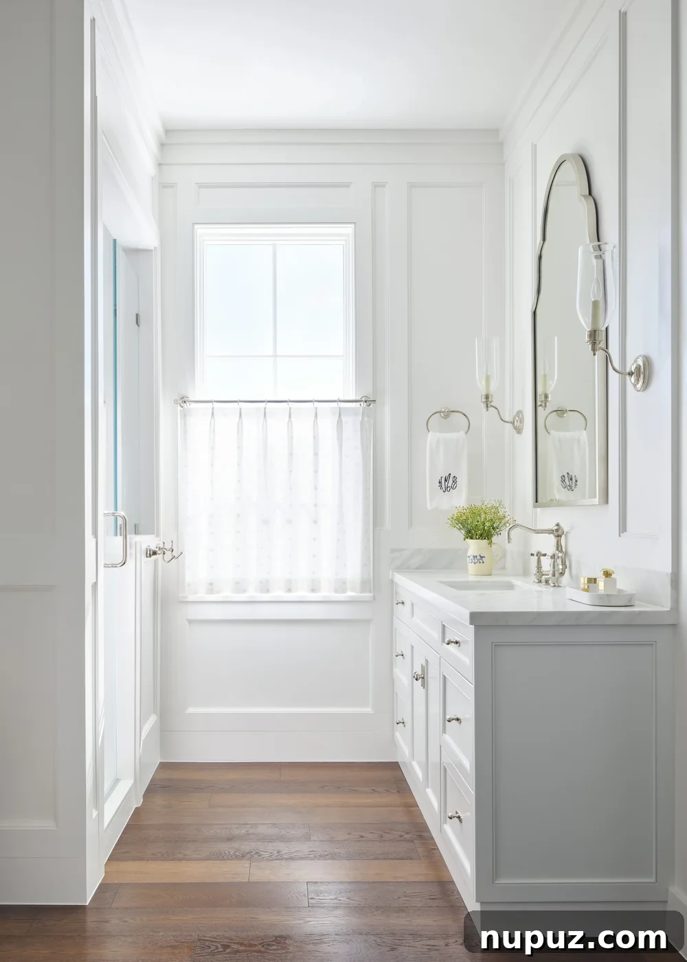 Kara Miller's Farmhouse Retreat 12 Stylish and functional bathroom with a unique custom vanity, modern fixtures, and elegant tiling, showcasing Kara Miller's design expertise. Photography by Brantley Photography.