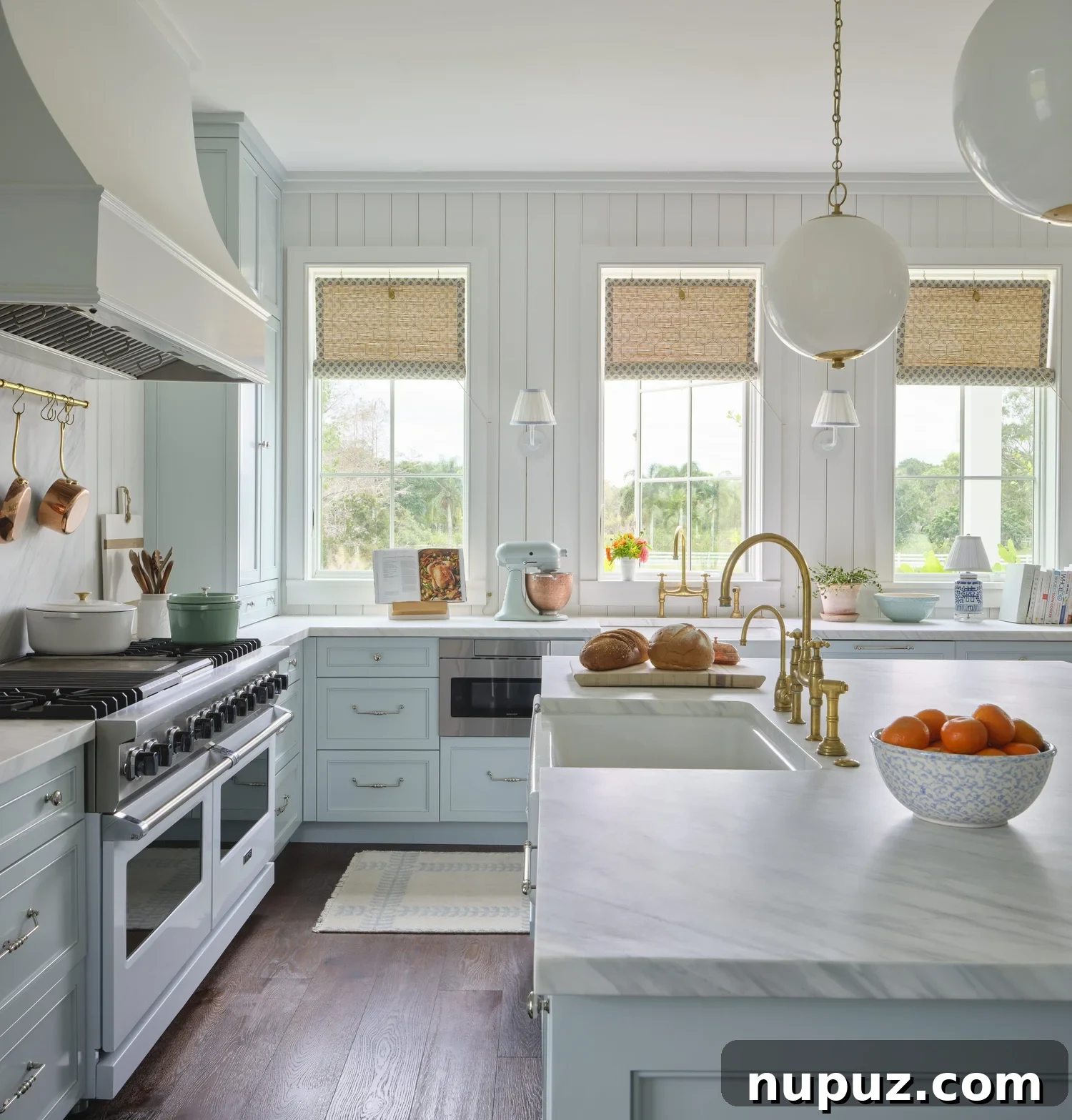 Kara Miller's Farmhouse Retreat 8 Luxurious master bedroom with a grand four-poster bed, elegant chandeliers, comfortable seating, and a sophisticated color palette, exemplifying Kara Miller's design. Photography by Brantley Photography.