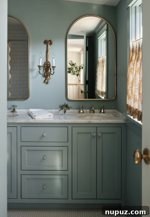 Layering for Impact: Interior Design with Stephanie Sabbe 8 A luxurious and moody blue bathroom designed by Sabbe Interior Design, embodying elegance and tranquility, captured by Joseph Bradshaw Photography.