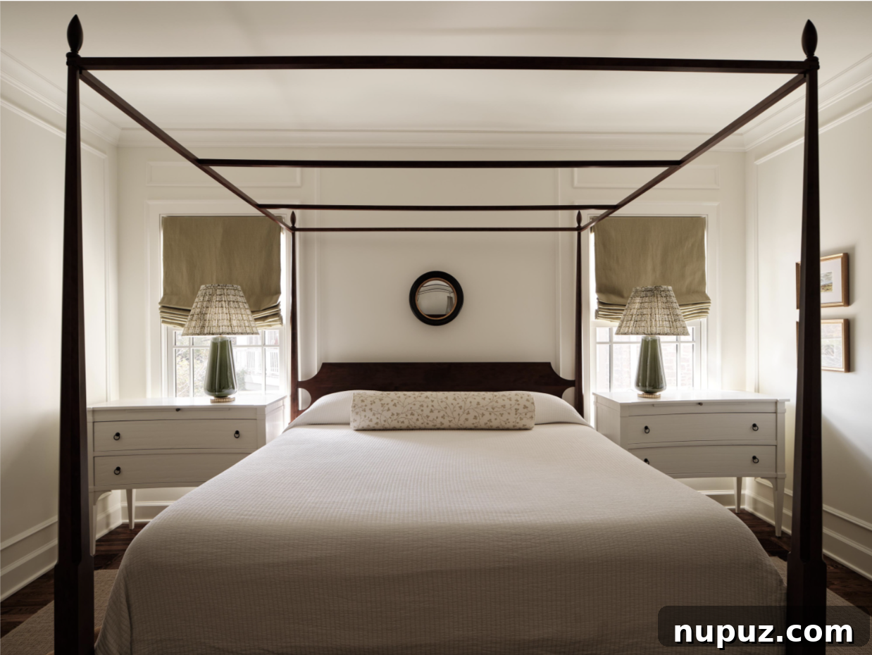 Serene and luxurious neutral bedroom with a stunning canopy bed, designed by Stephanie Sabbe to be a tranquil retreat, blending comfort with refined style.