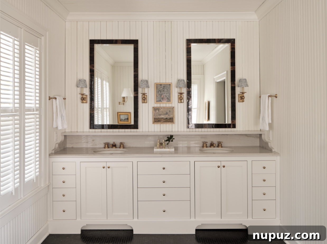 Luxurious and highly functional bathroom designed by Stephanie Sabbe, featuring double sinks, matching mirrors, and premium finishes that create a spa-like experience.