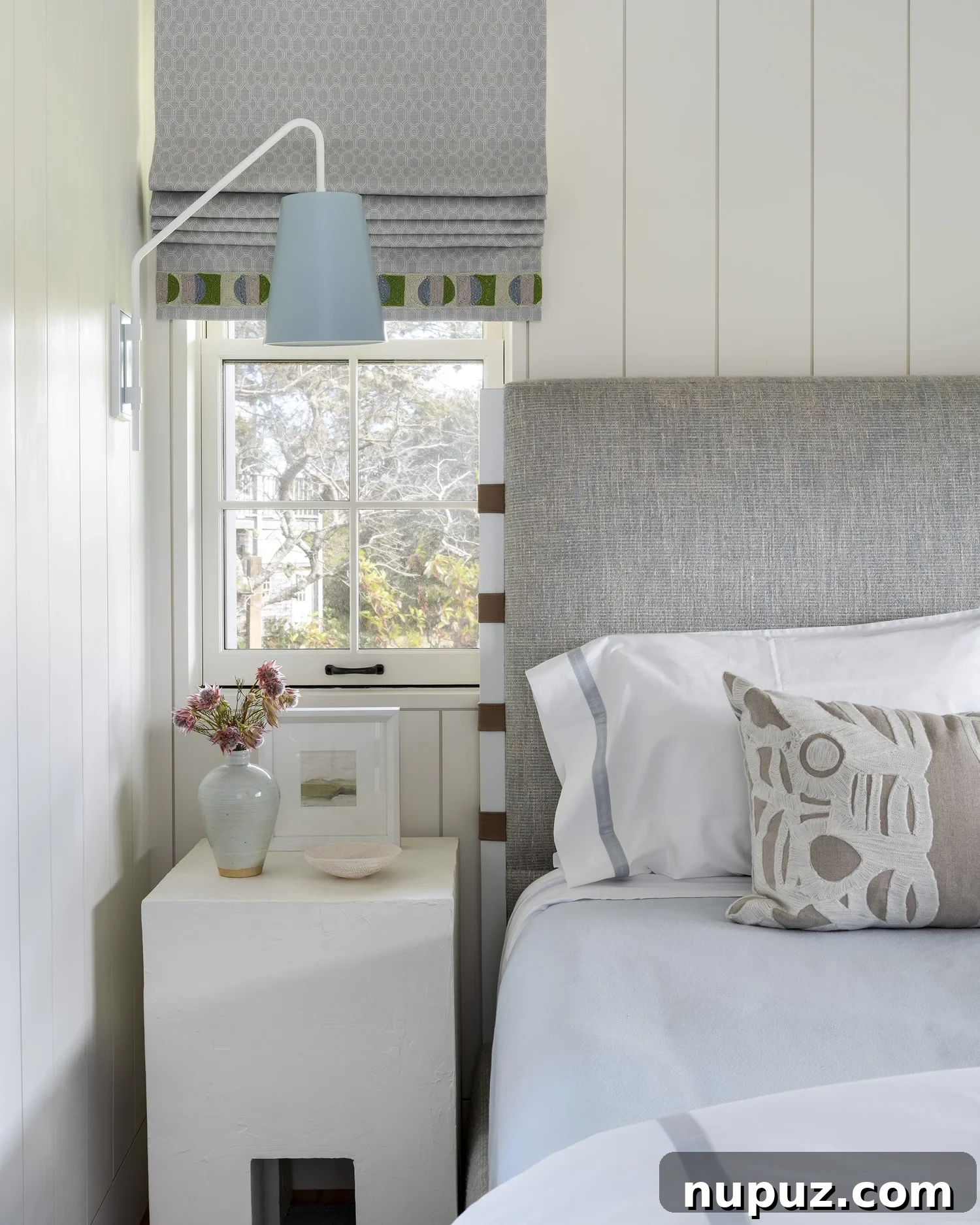 Nantucket's Timeless Coastal Sanctuary Unveiled 7 Peaceful neutral bedroom with elegant Roman shades, exuding comfort and serenity in a Nantucket coastal home