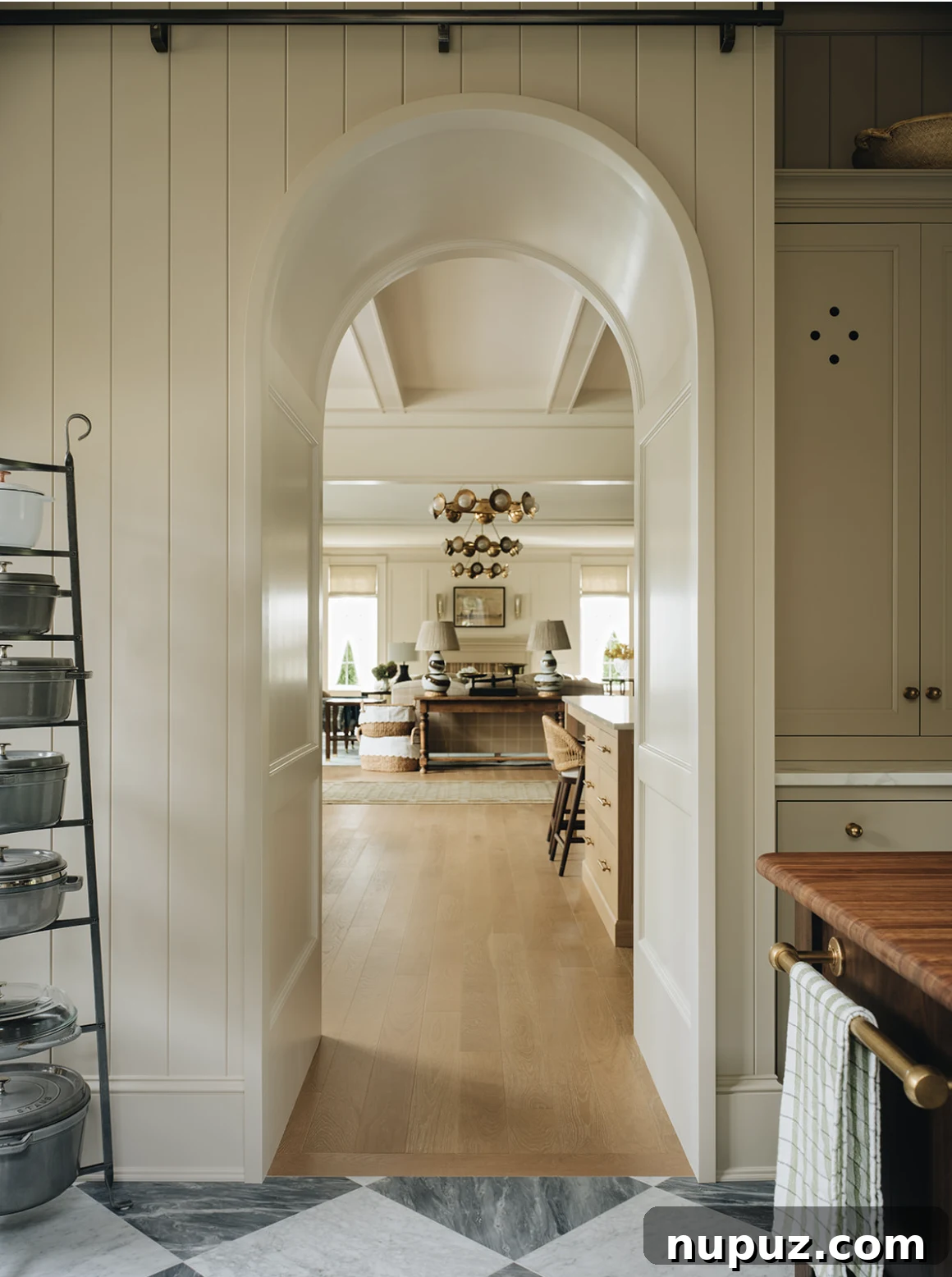 Infuse Your Space with Soul: Creative Home Decor Inspirations 11 Spacious kitchen featuring a large blonde wood island with comfortable counter stools, showcasing impeccable design and a welcoming atmosphere.