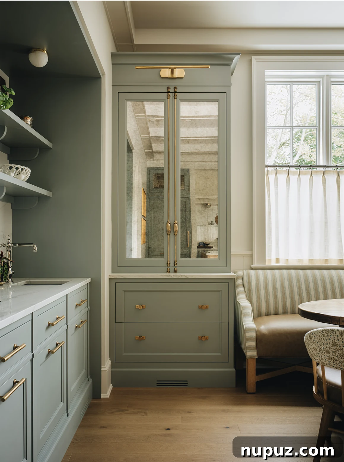 Infuse Your Space with Soul: Creative Home Decor Inspirations 13 Stylish kitchen showcasing beautiful green cabinets with luxurious gold hardware, complemented by a cozy banquette dining area, perfect for intimate meals.
