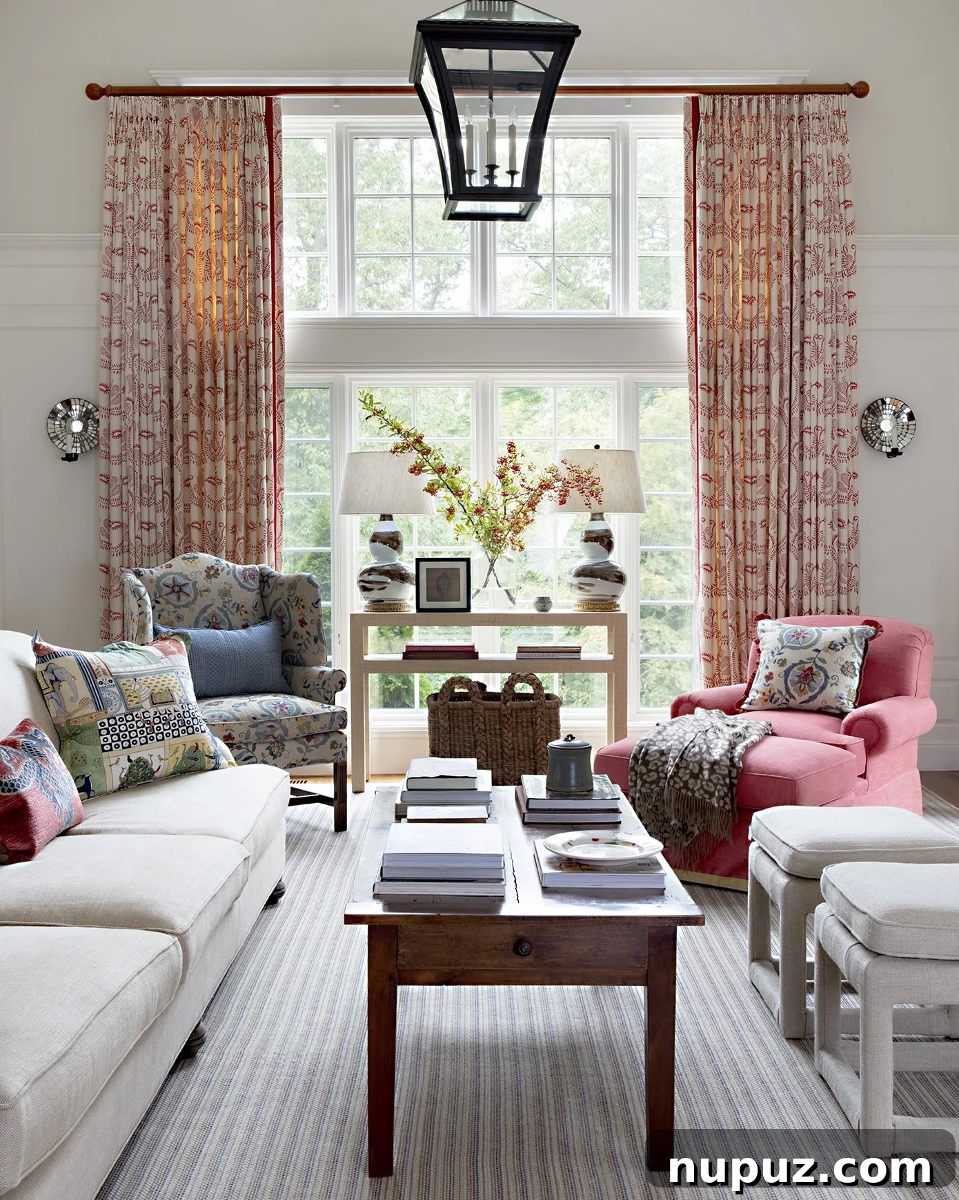 Bright and airy living room featuring elegant white sofas and a large modern coffee table by Honey Collins Interiors.