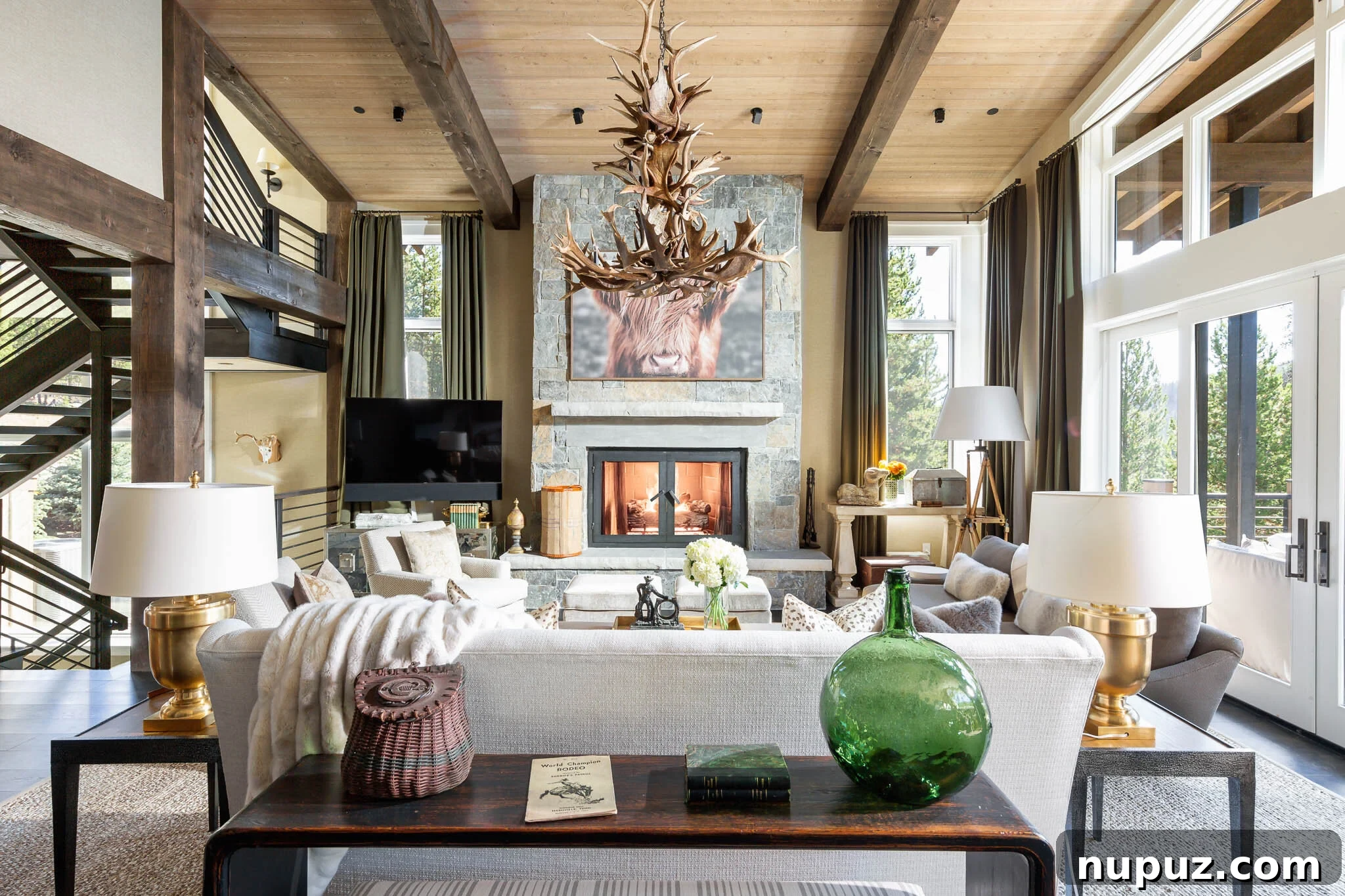 Elegant living room with a grand fireplace, two large sofas facing each other with plush cushions, a central coffee table, and intricate architectural details.
