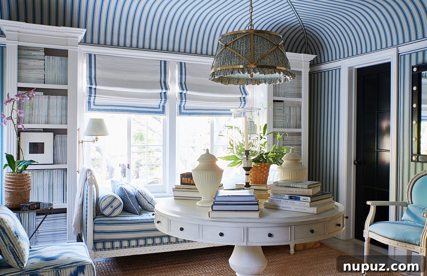 Step inside a sophisticated living room designed by Mark D. Sikes, featuring elegant blue and white decor, comfortable seating, and tasteful accessories. This image beautifully captures the essence of a designer's home, exuding timeless style and refined taste.