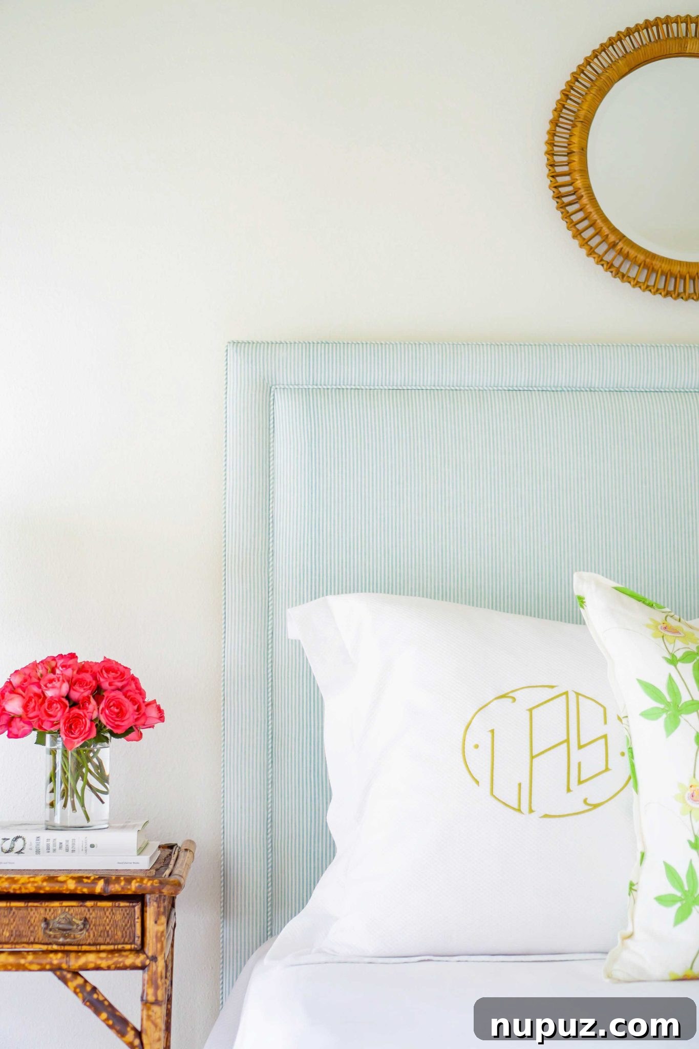Lindley Arthur's Signature Style: 10 Breathtaking Interiors 6 Lindley Arthur Interiors blue bedroom with a luxurious upholstered headboard, a stylish round mirror, and serene decor elements.