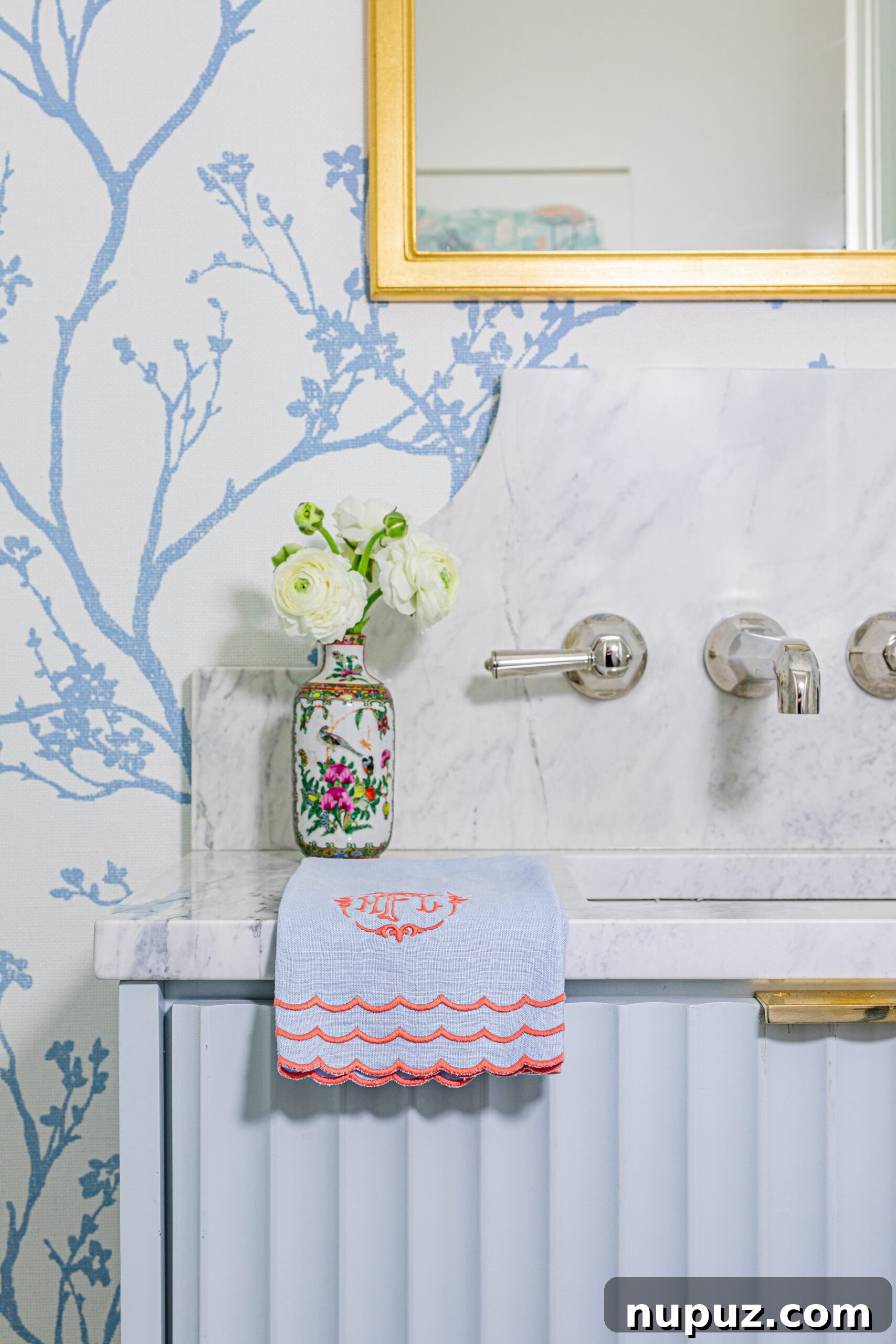 Lindley Arthur's Signature Style: 10 Breathtaking Interiors 9 Lindley Arthur Interiors bathroom with elegant blue and white hand-painted wallpaper, a sophisticated vanity, and timeless design elements.