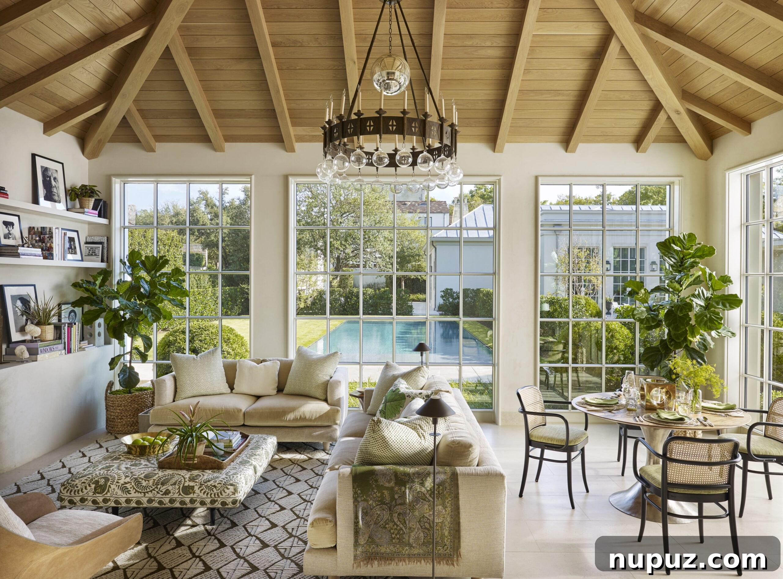 Effortless Elegance: Tom Scheerer's Interior Design Insights 6 Tom Scheerer's STILL DECORATING features a breathtaking living room with a grand cathedral ceiling and exposed wood beams, creating a spacious and inviting atmosphere.