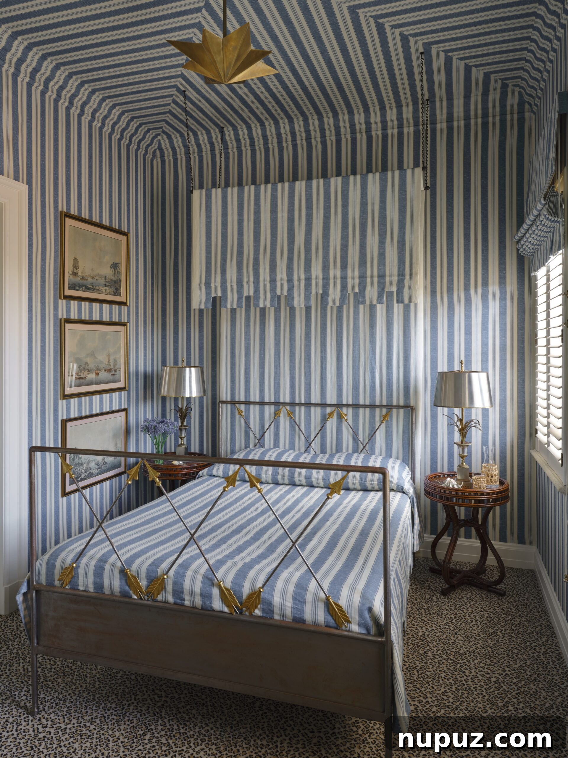 Effortless Elegance: Tom Scheerer's Interior Design Insights 7 A beautiful blue and white bedroom from Tom Scheerer's STILL DECORATING, featuring a harmonious mix of blue and white striped wallpaper and matching bedding, embodying a serene and classic coastal aesthetic.