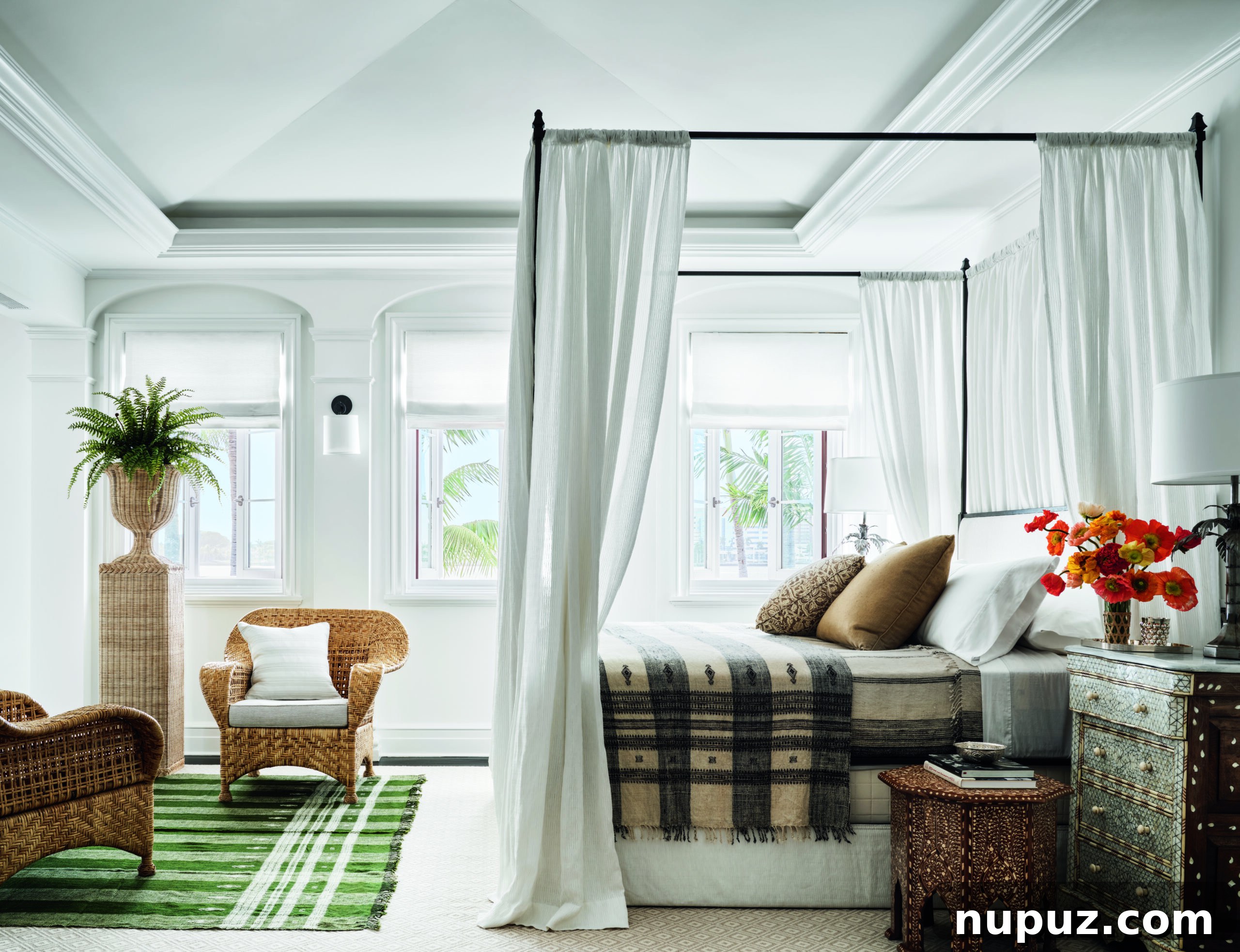 Designing Your Magnificent Life 5 A second view of an exquisitely designed blue and white themed bedroom, featuring a magnificent canopy bed and curated decor, offering further insights into the captivating interiors of Hilfiger Homes.