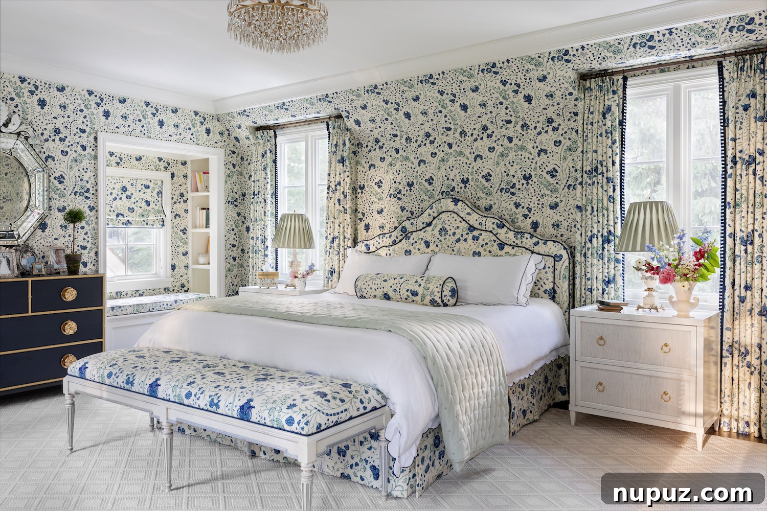 Alexandra Kaehler's serene bedroom design, featuring crisp white bedding, a unique bedside table, and abundant natural light, creating a peaceful retreat.