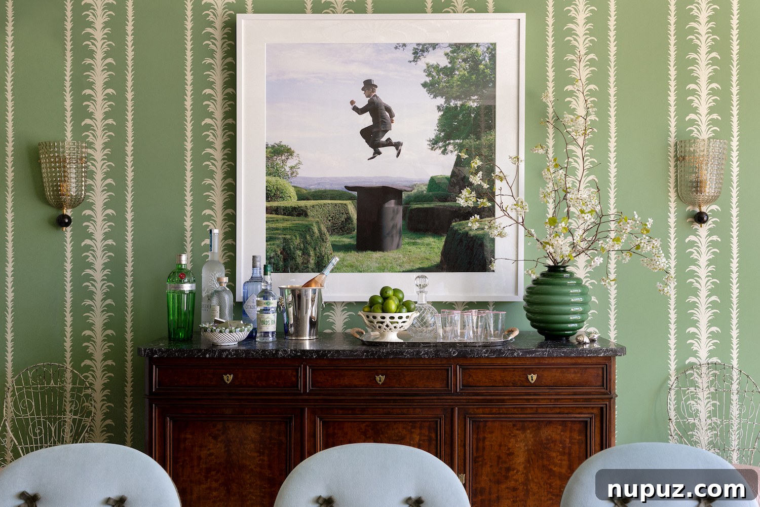 Alexandra Kaehler's chic home office or library space, featuring dark wood built-in bookshelves, a comfortable armchair, and classic decor elements.