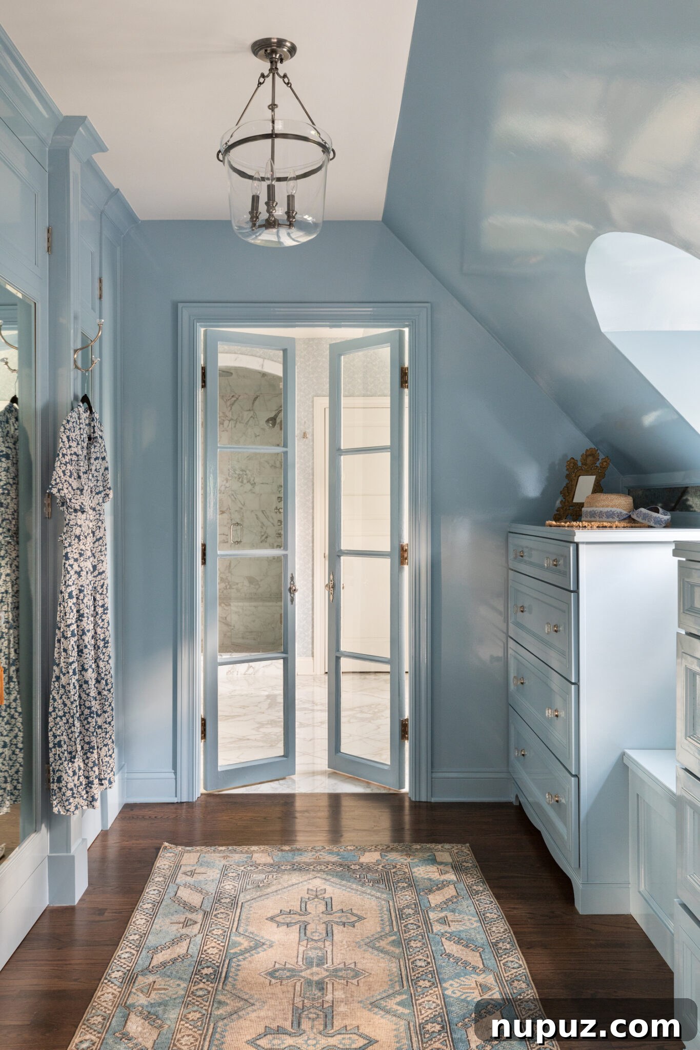 A chic hallway or gallery space designed by Alexandra Kaehler, showcasing framed art, a stylish console table, and a statement mirror.