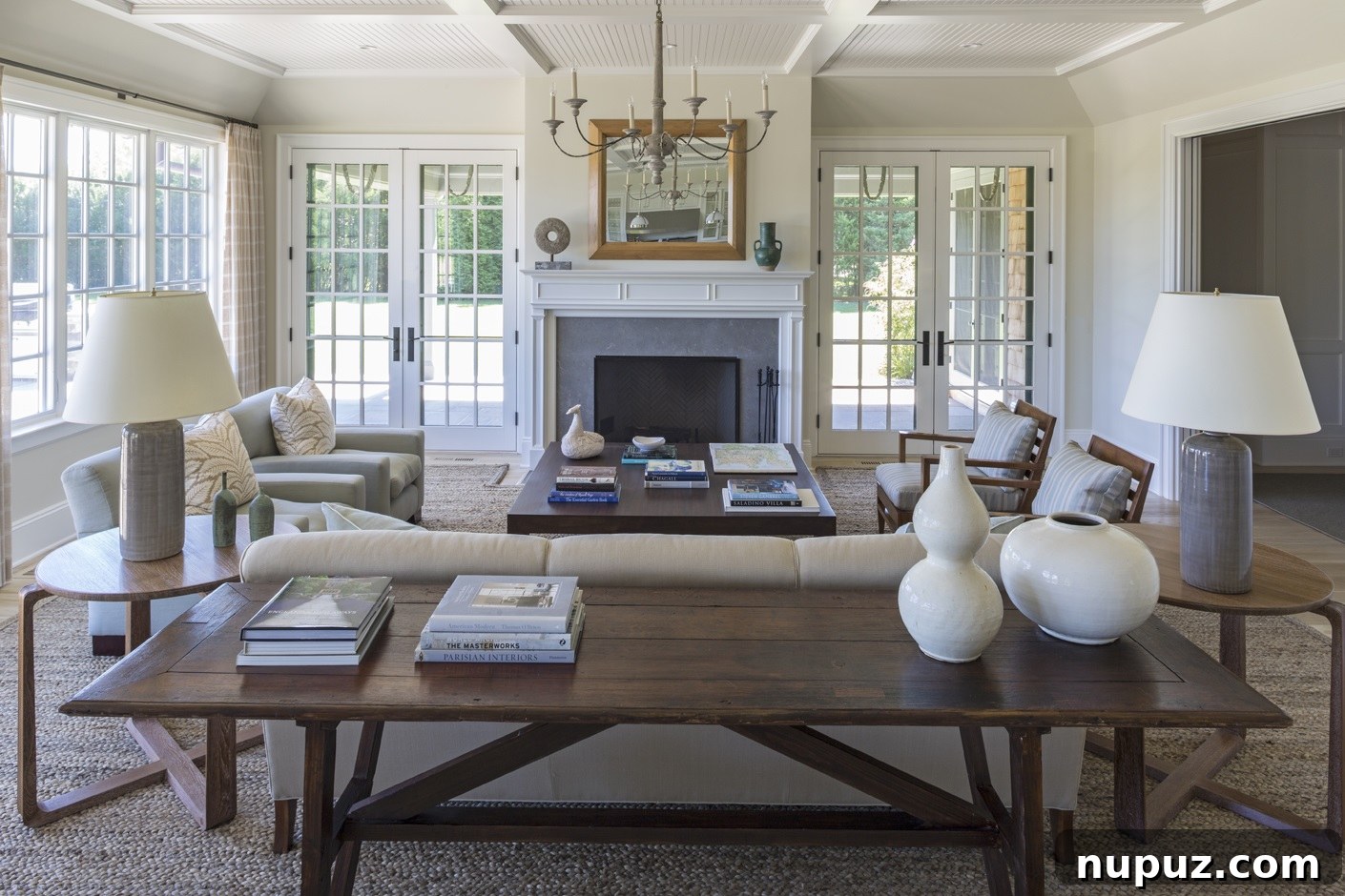 A beautifully arranged living room corner featuring a classic armchair, a stylish side table with curated decor, and a large window inviting natural light. Designed by Brady Design.