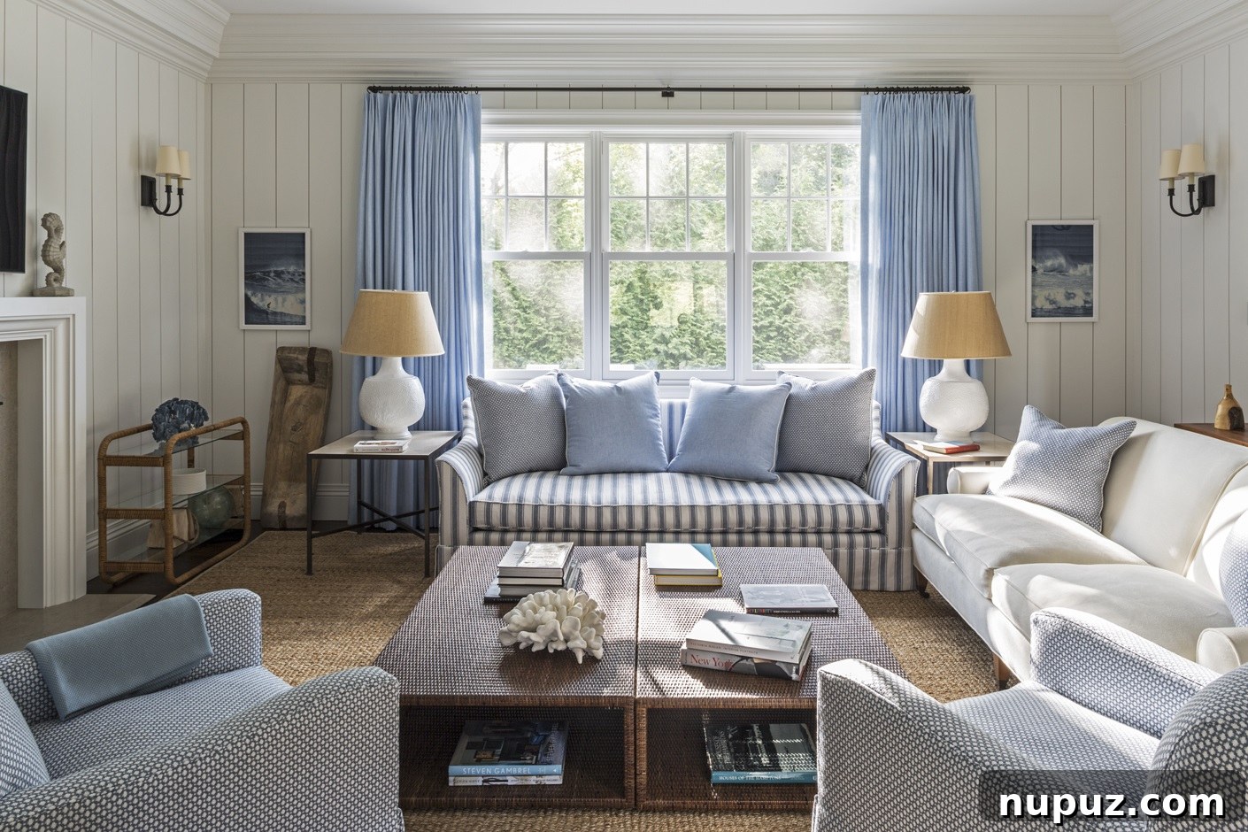 Chic living room featuring a comfortable sofa, unique art pieces, and a stylish console table, all contributing to a cohesive and inviting aesthetic. A Brady Design project photographed by Marco Ricca.