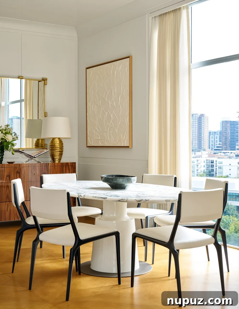 10 Exquisite Dining Rooms by Mary Beth Wagner 11 A cozy yet elegant dining room by Mary Beth Wagner, featuring a round table, unique chairs, and a charming vignette. Photographed by Nathan Schroder.