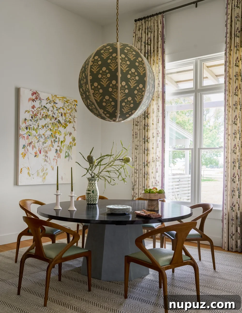 10 Exquisite Dining Rooms by Mary Beth Wagner 9 An elegantly styled dining room featuring a large rectangular table, comfortable upholstered chairs, and a striking piece of artwork. Photographed by Nathan Schroder.