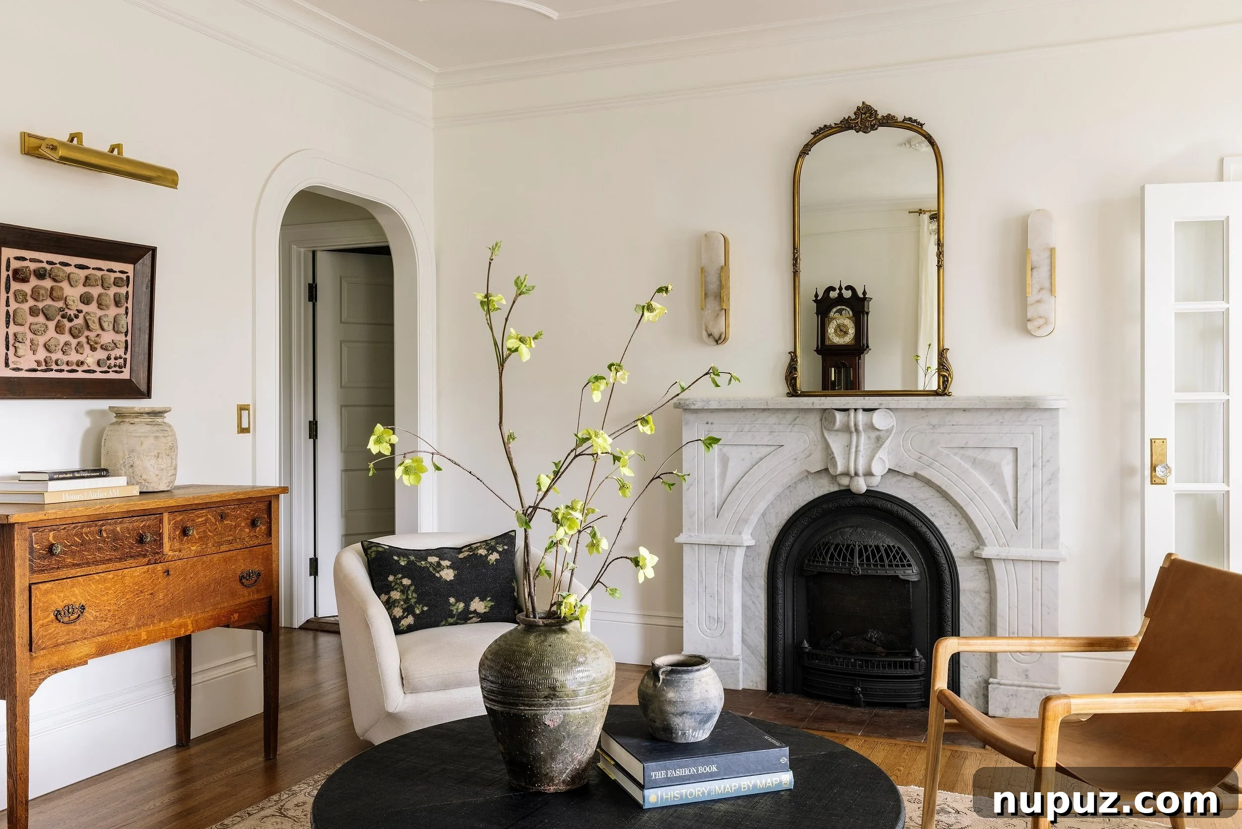 Imparfait Design Studio designed living room with a neutral palette, plush seating, and elegant coffee table, bathed in natural light.
