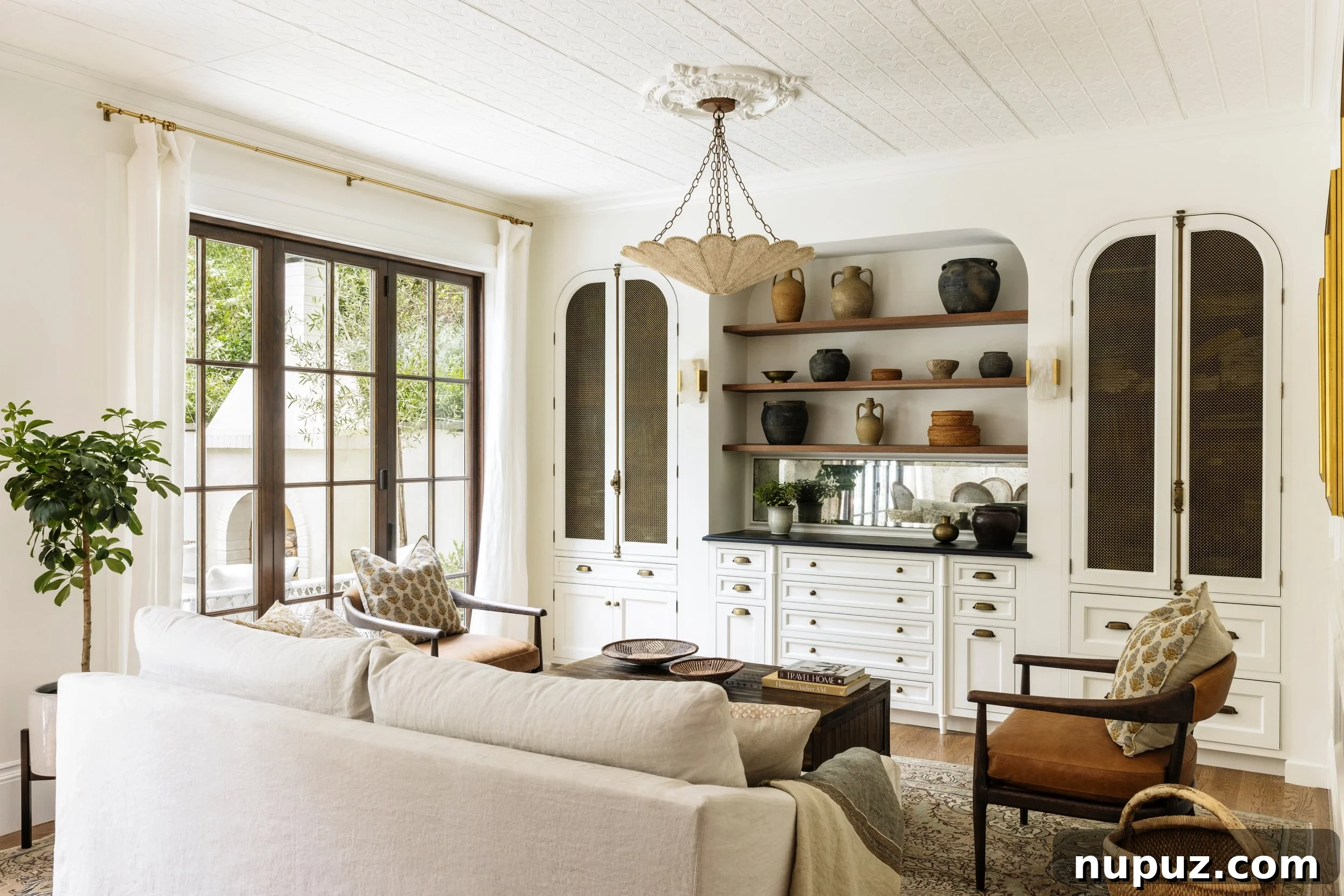 Elegant Imparfait Design Studio living room with a large, comfortable sofa, modern fireplace, and minimalist decor.
