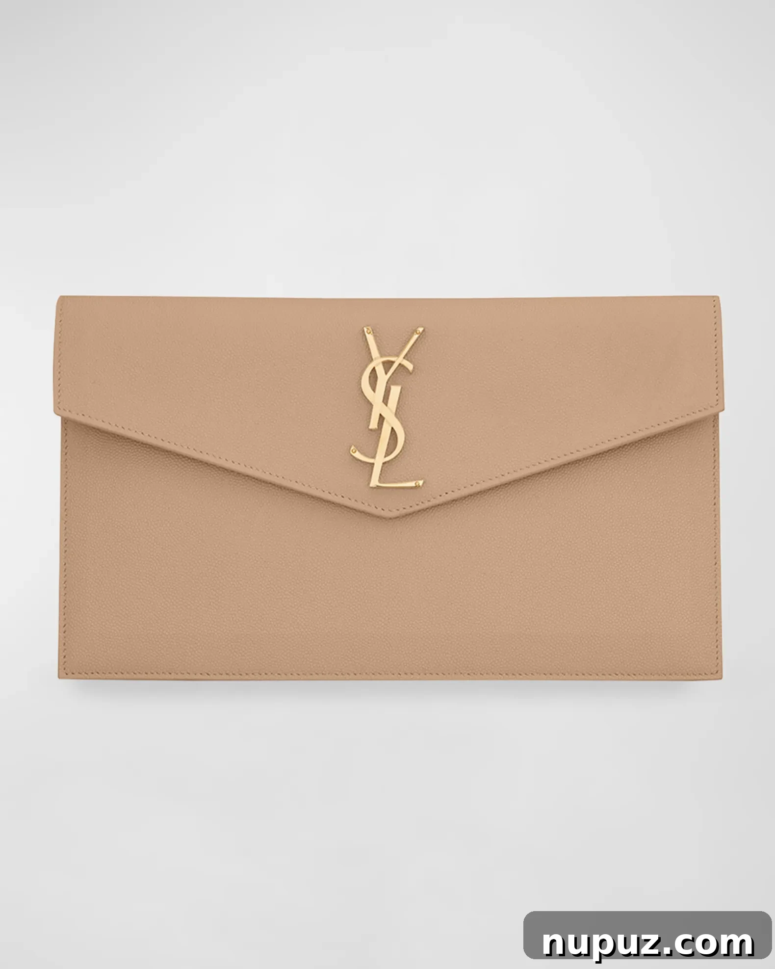 A chic holiday gift guide image, featuring a YSL clutch and other luxury items from Neiman Marcus