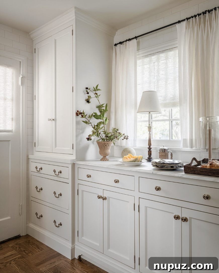 Chic and grand hallway or entryway design by Marianne Simon Interiors, making a dramatic and welcoming first impression with elegant wall treatments and art. Stylist @cate.ragan.styling Photography @_karamercer